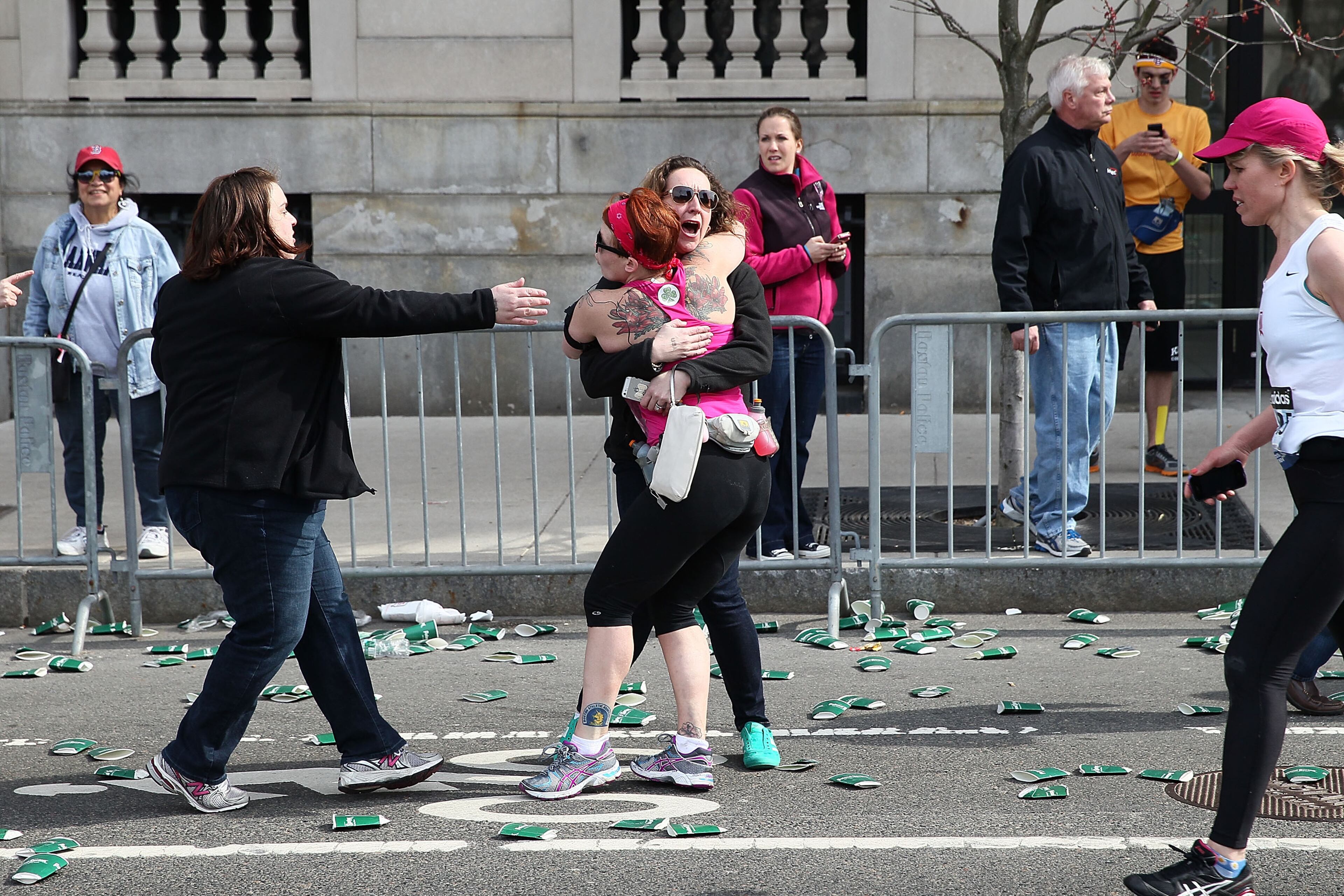 BOSTON, MA - APRIL 15: A runner embraces another woman on the marathon route near Kenmore Square after two bombs exploded during the 117th Boston Marathon on April 15, 2013 in Boston, Massachusetts. Two people are confirmed dead and at least 23 injured after two explosions went off near the finish line to the marathon. (Photo by Alex Trautwig/Getty Images)