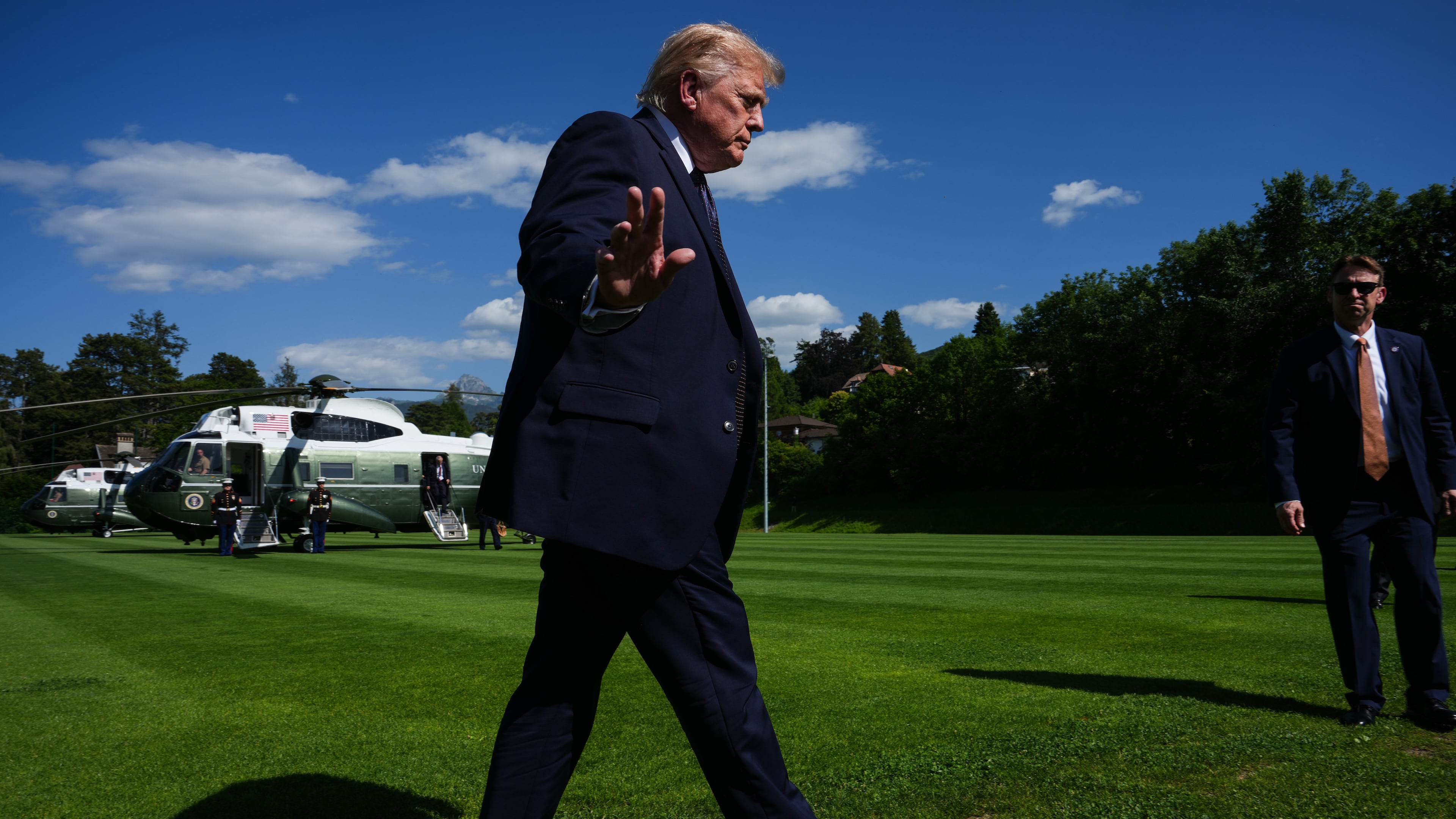 President Donald Trump waves to reporters as he arrives for the G7 summit, Monday, June 15, 2026, in Evian-les-Bains, France. (AP Photo/Julia Demaree Nikhinson)