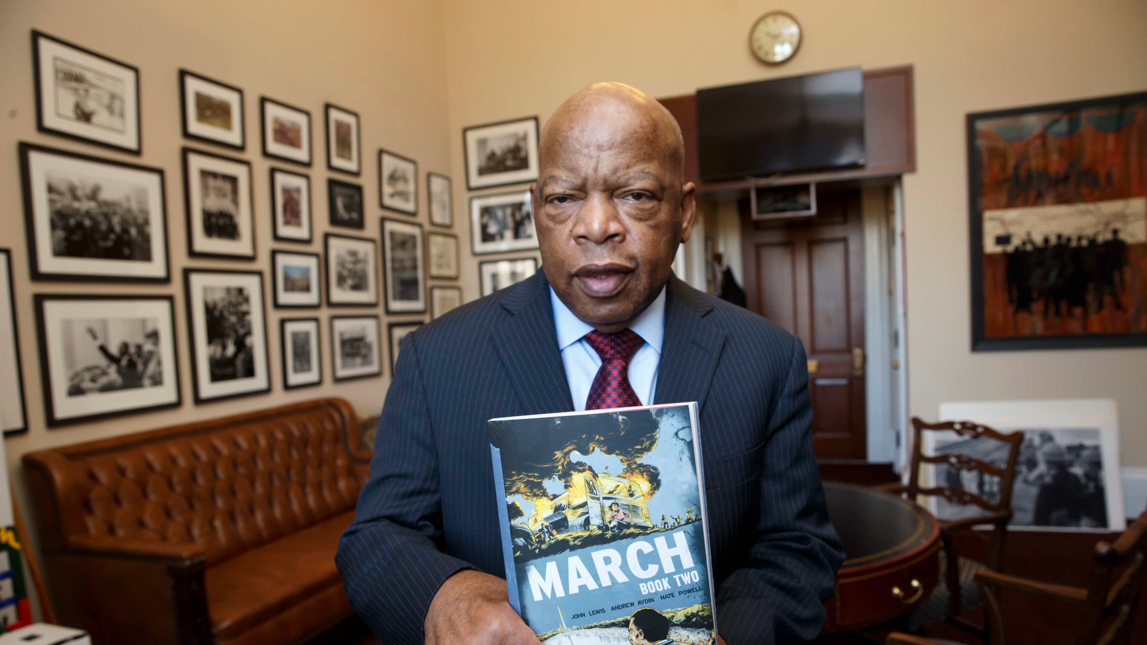 Rep. John Lewis, D-Ga., holds the new installment of his award-winning graphic novel on civil rights and nonviolent protest, on Capitol Hill in Washington. A comic book about Martin Luther King Jr. helped bring John Lewis into the civil rights movement. The longtime Democratic congressman from Georgia now hopes that graphic novels about his life and what his contemporaries endured to overcome racism will guide today's protesters in search of justice. (AP Photo/J. Scott Applewhite)