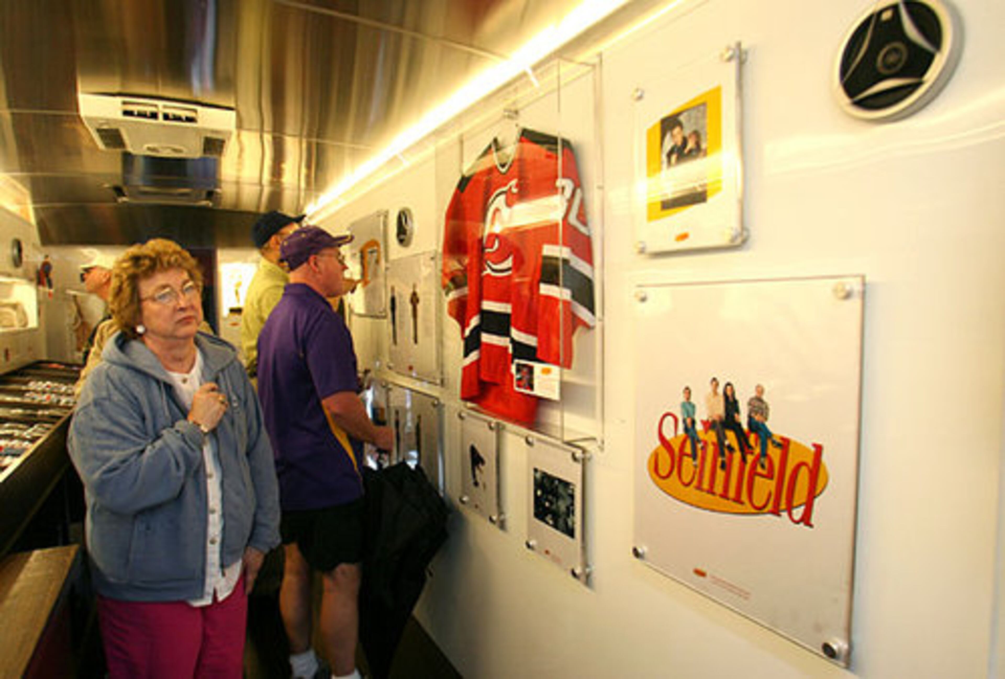 Laverl Terry of Conway, Ark., looks at Seinfeld memorabila on displayed inside the 'Seinfeld' bus parked outside Turner Field on Monday. The Seinfeld Campus Tour, a 22-city bus tour, is a "Seinfeld" experience designed to introduce college students and a new audience of fans to the Seinfeld sitcom.