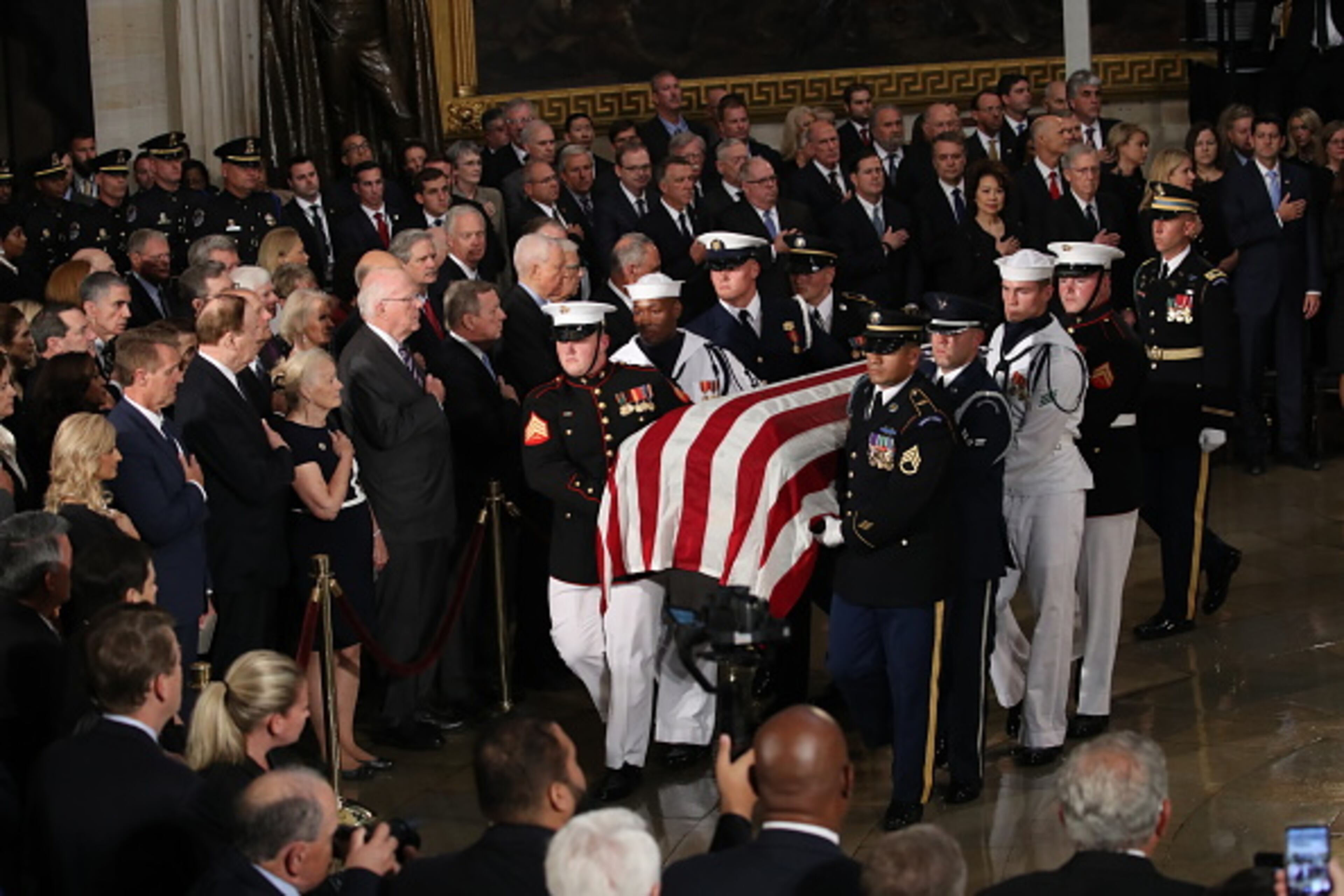WASHINGTON, DC - AUGUST 31: The flag-draped casket of US Senator John McCain arrives inside the Rotunda of the U.S. Capitol, August 31, 2018 in Washington, DC. A Democrat who voted for Hillary Clinton, Farone said McCain did what was right. "He never took the easy way out, he knew actions speak louder than words and he never tweeted about it. He just got it done," she said. The late senator died August 25 at the age of 81 after a long battle with brain cancer. He will lie in state at the U.S. Capitol Friday, a rare honor bestowed on only 31 people in the past 166 years. Sen. McCain will be buried at his final resting place at the U.S. Naval Academy on Sunday. (Photo by Drew Angerer/Getty Images)