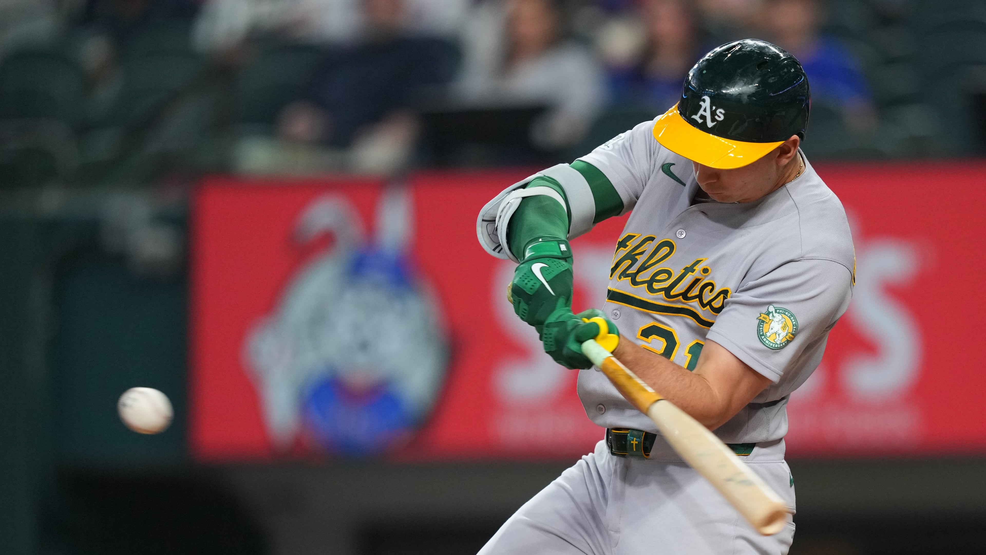 Athletics' Tyler Soderstrom swings at a pitch from Texas Rangers starting pitcher Nathan Eovaldi while connecting on a solo home run during the first inning of a baseball game Friday, April 24, 2026, in Arlington, Texas. (AP Photo/Julio Cortez)