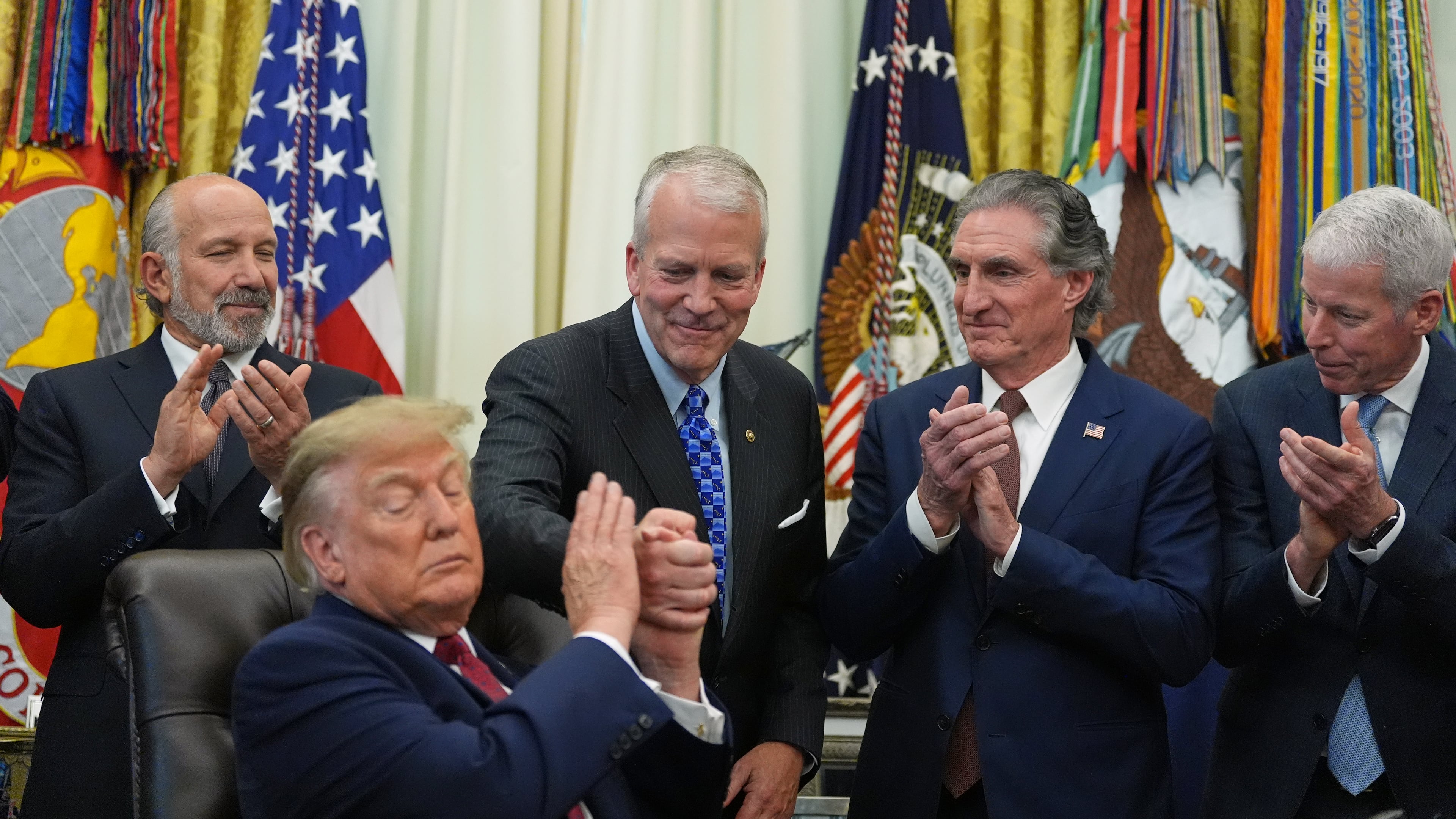President Donald Trump shakes hands with Sen. Dan Sullivan, R-Alaska, as he speaks in the Oval Office of the White House, Wednesday, Sept. 30, 2026, in Washington, as Commerce Secretary Howard Lutnick, Interior Secretary Doug Burgum and Energy Secretary Chris Wright applaud. (AP Photo/Alex Brandon)