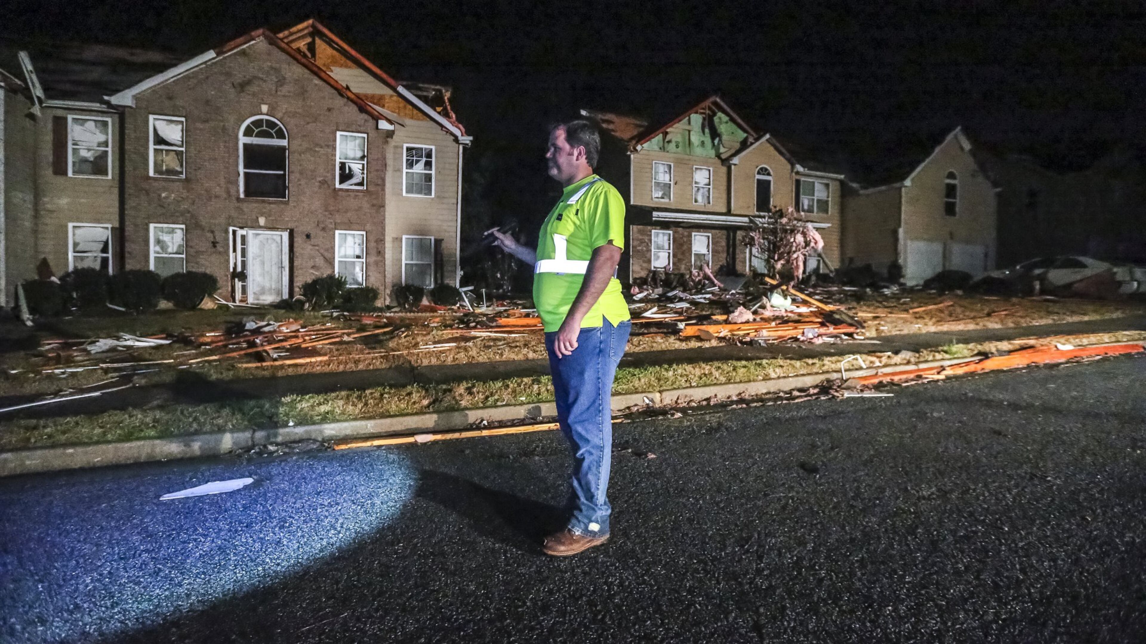 Cal Welk with Champion Construction surveys damage on Jumpers Trail on Tuesday after a powerful storm system swept through North Georgia Monday, sending trees into roads, damaging homes and businesses, knocking out power to thousands. JOHN SPINK/JSPINK@AJC.COM