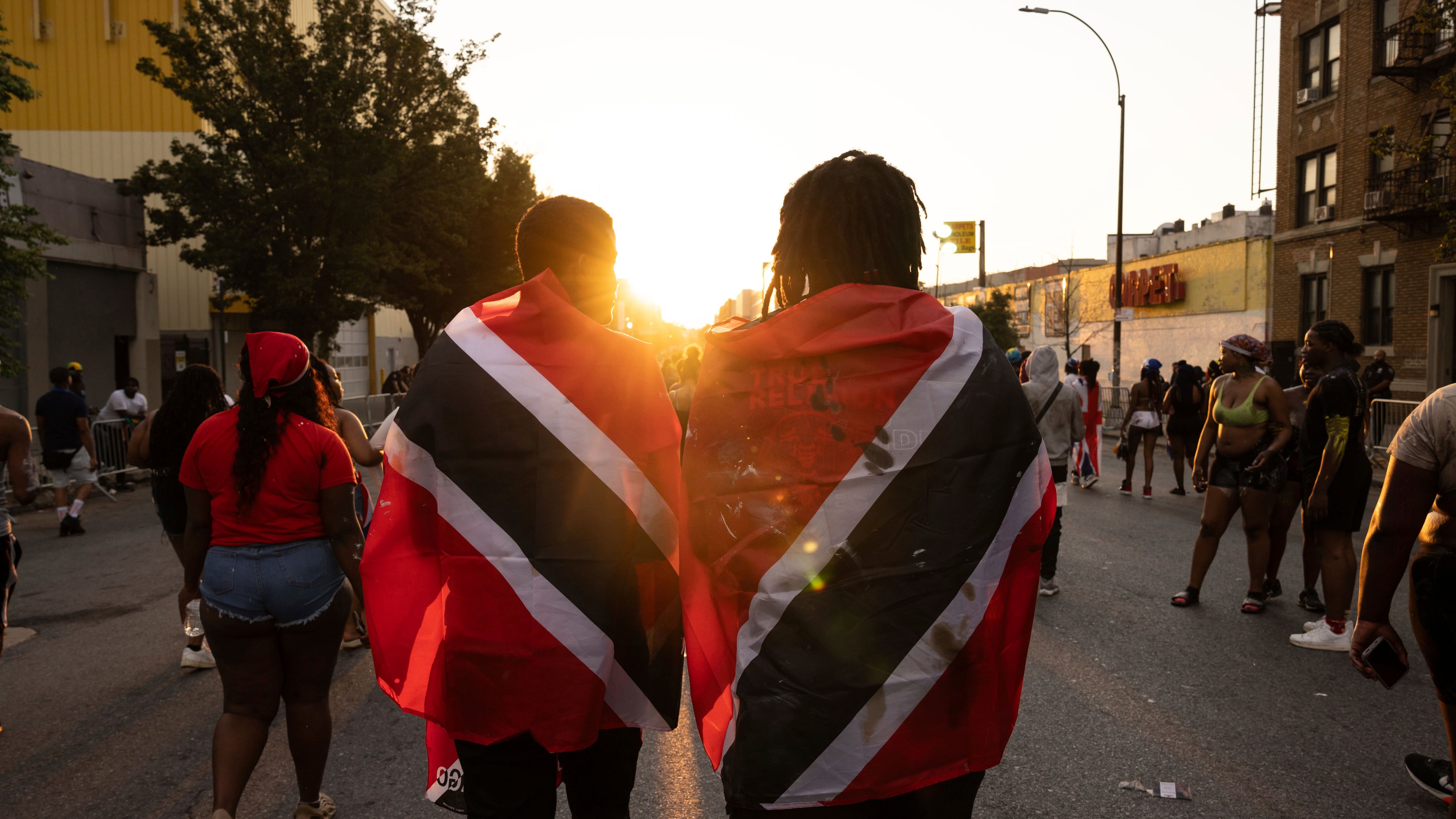 FILE - People with Trinidad and Tobago flag are seen during J'ouvert celebration, Sept. 4, 2023, in the Brooklyn borough of New York. (AP Photo/Yuki Iwamura, File)