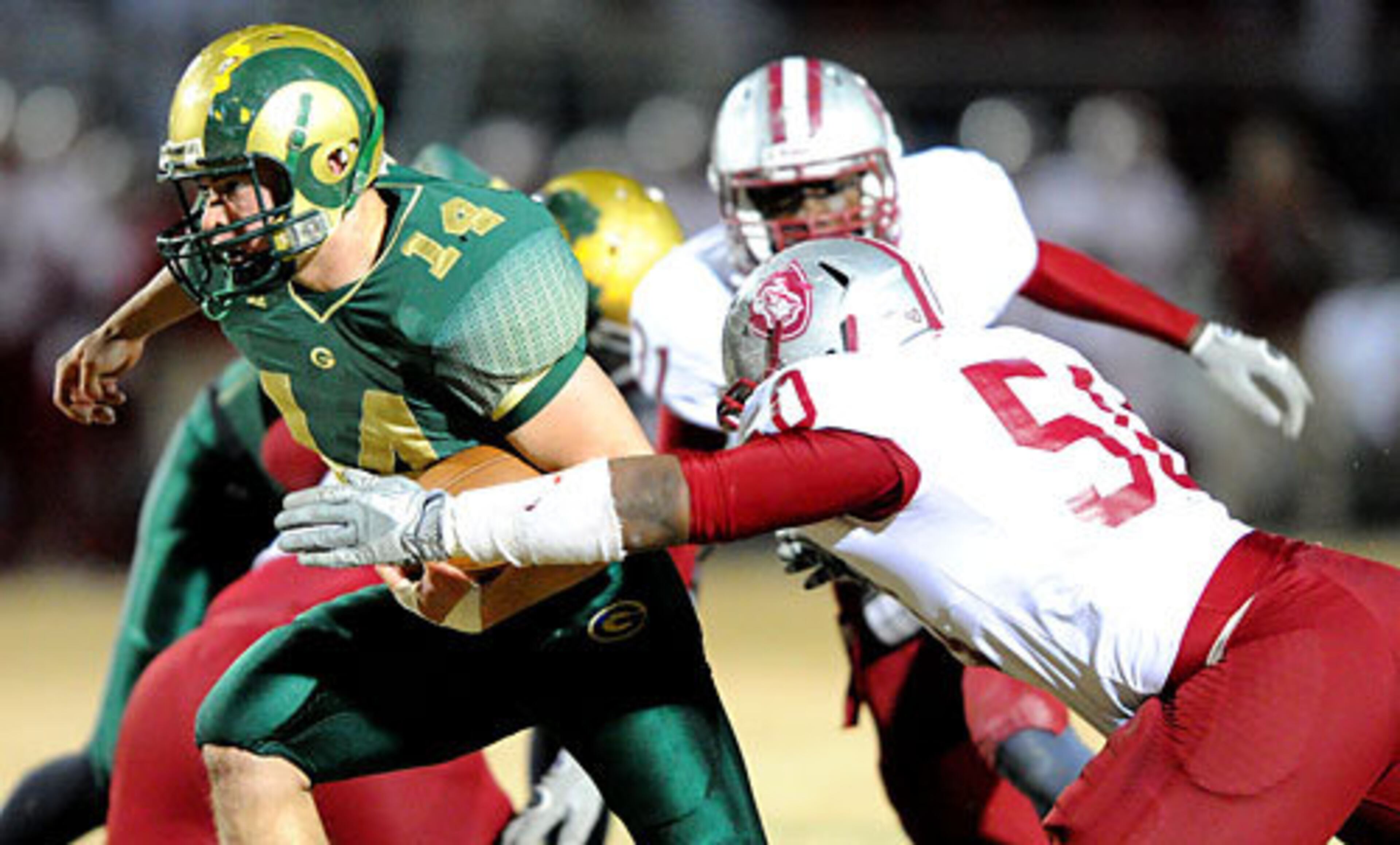 Grayson's Devin Gillespie (14) is tackled by Lowndes' Larenick Rollins (50).