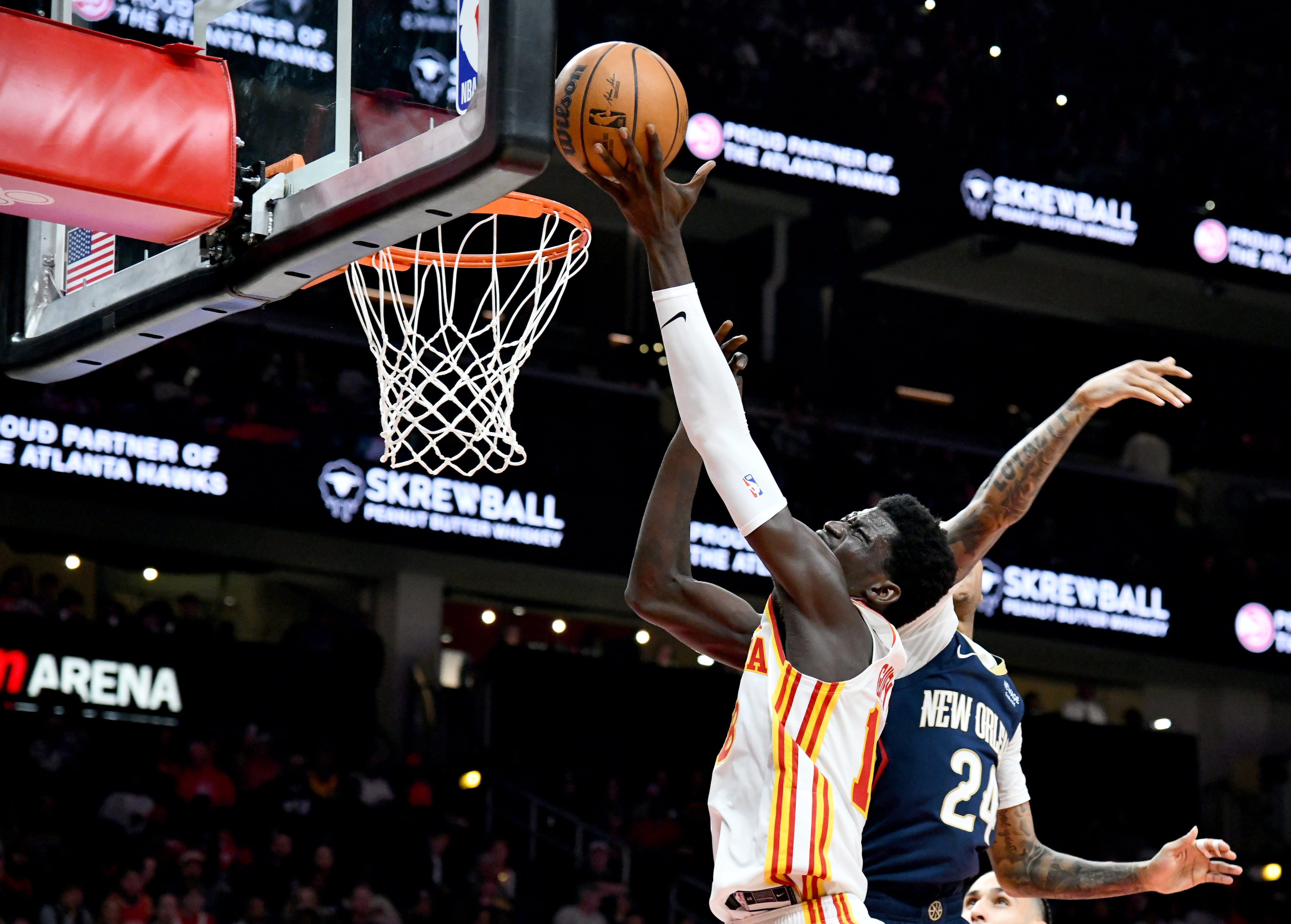 Atlanta Hawks forward Mouhamed Gueye (18) goes to the basket for the shot past New Orleans Pelicans guard Jordan Hawkins (24) during the first half in an NBA basketball game at State Farm Arena, Wednesday, Jan. 7, 2026, in Atlanta. (Hyosub Shin/AJC)