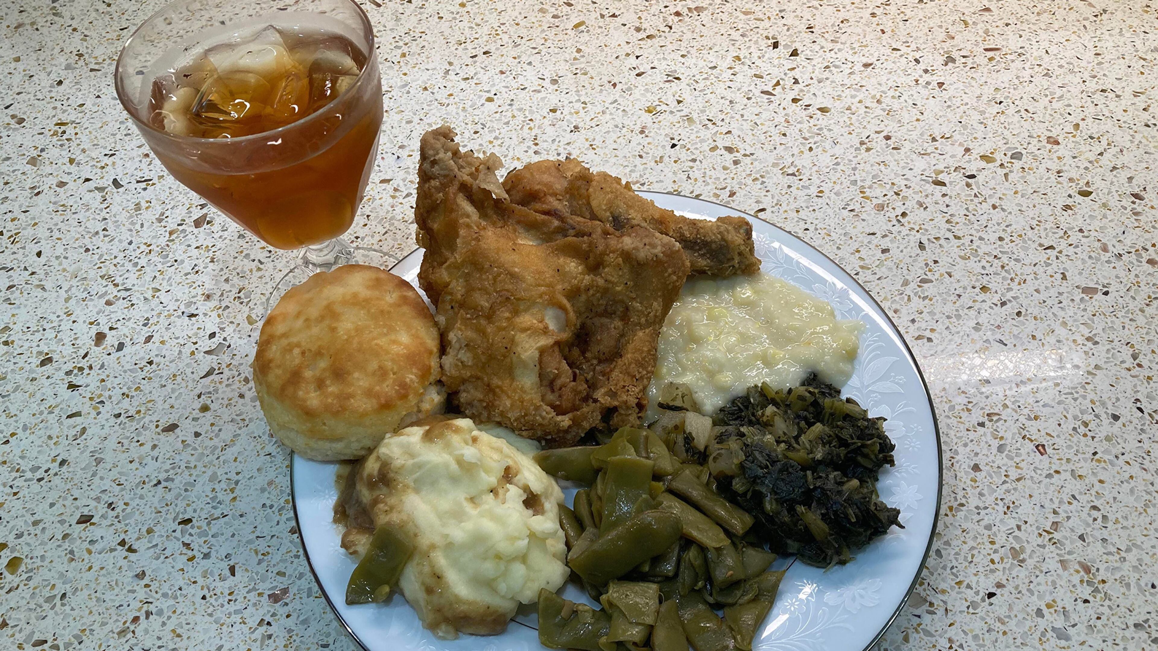 This re-creation of a typical Sunday dinner at Grandma King’s includes fried chicken, creamed corn, turnip greens, green beans, mashed potatoes, a biscuit and iced tea. (Bill King for The Atlanta Journal-Constitution)