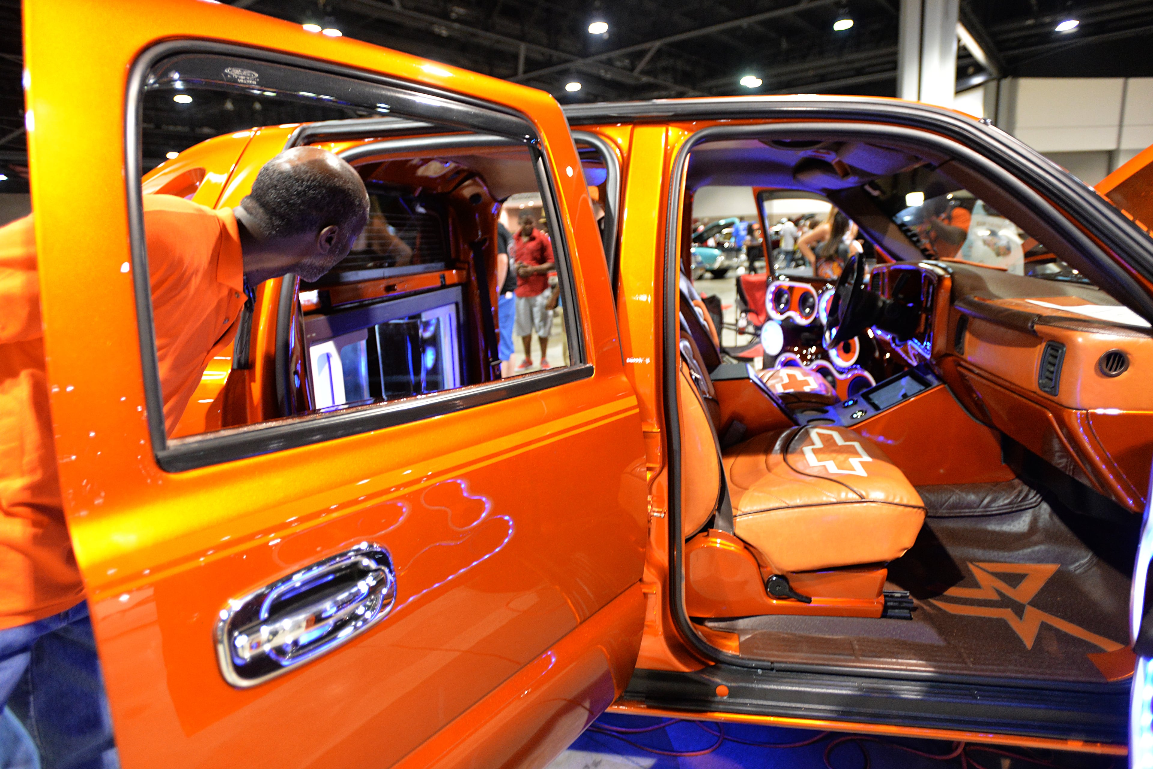 An event-goers takes a look inside a custom vehicle during The 2014 V-103/WAOK Car & Bike Show at the Georgia World Congress Center on Saturday, July 12, 2014.