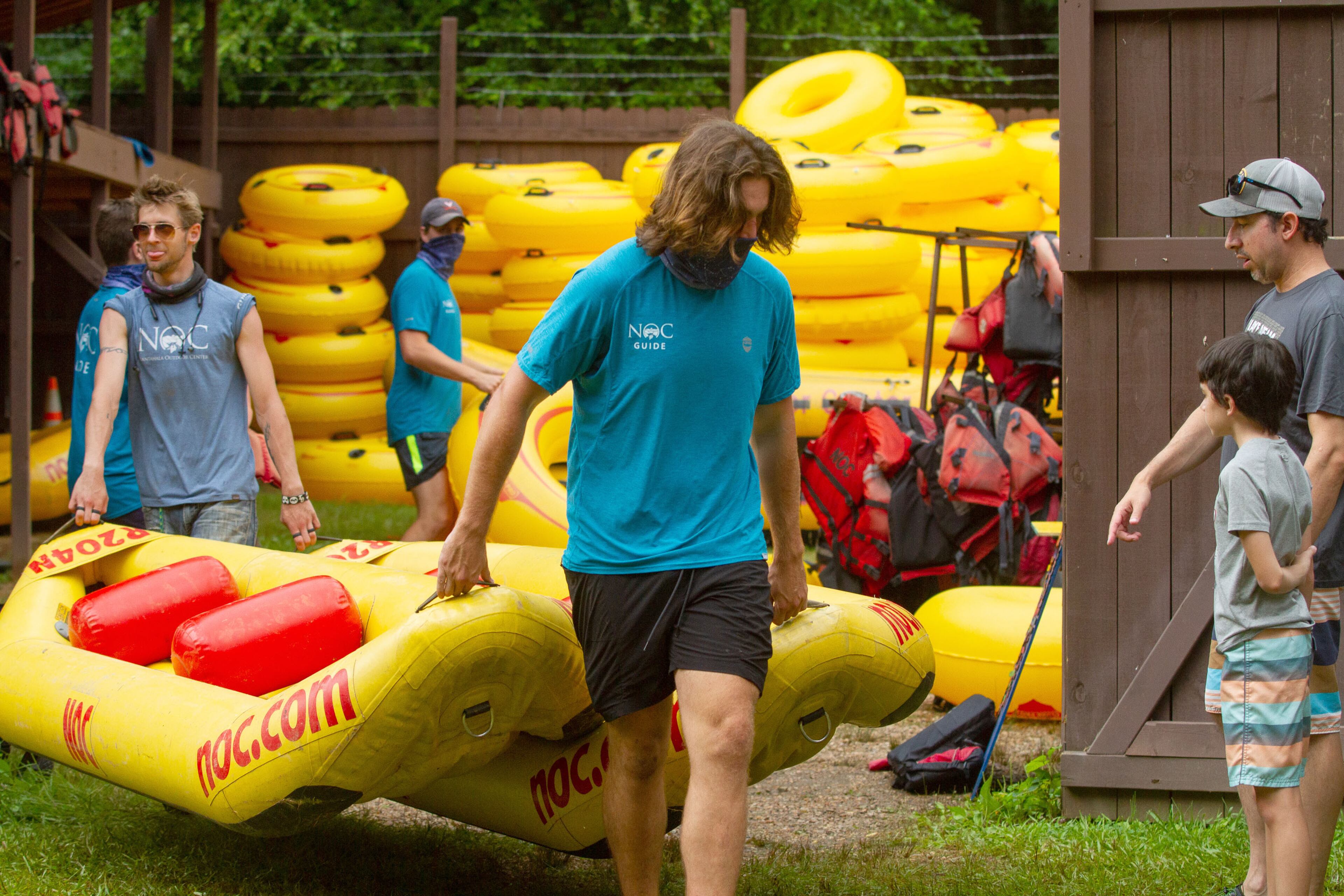 Nantahala Outdoor Center employees get rafts and inner tubes ready for customers at the Powers Island Park in Sandy Springs on Sunday, June 28, 2020. STEVE SCHAEFER FOR THE ATLANTA JOURNAL-CONSTITUTION