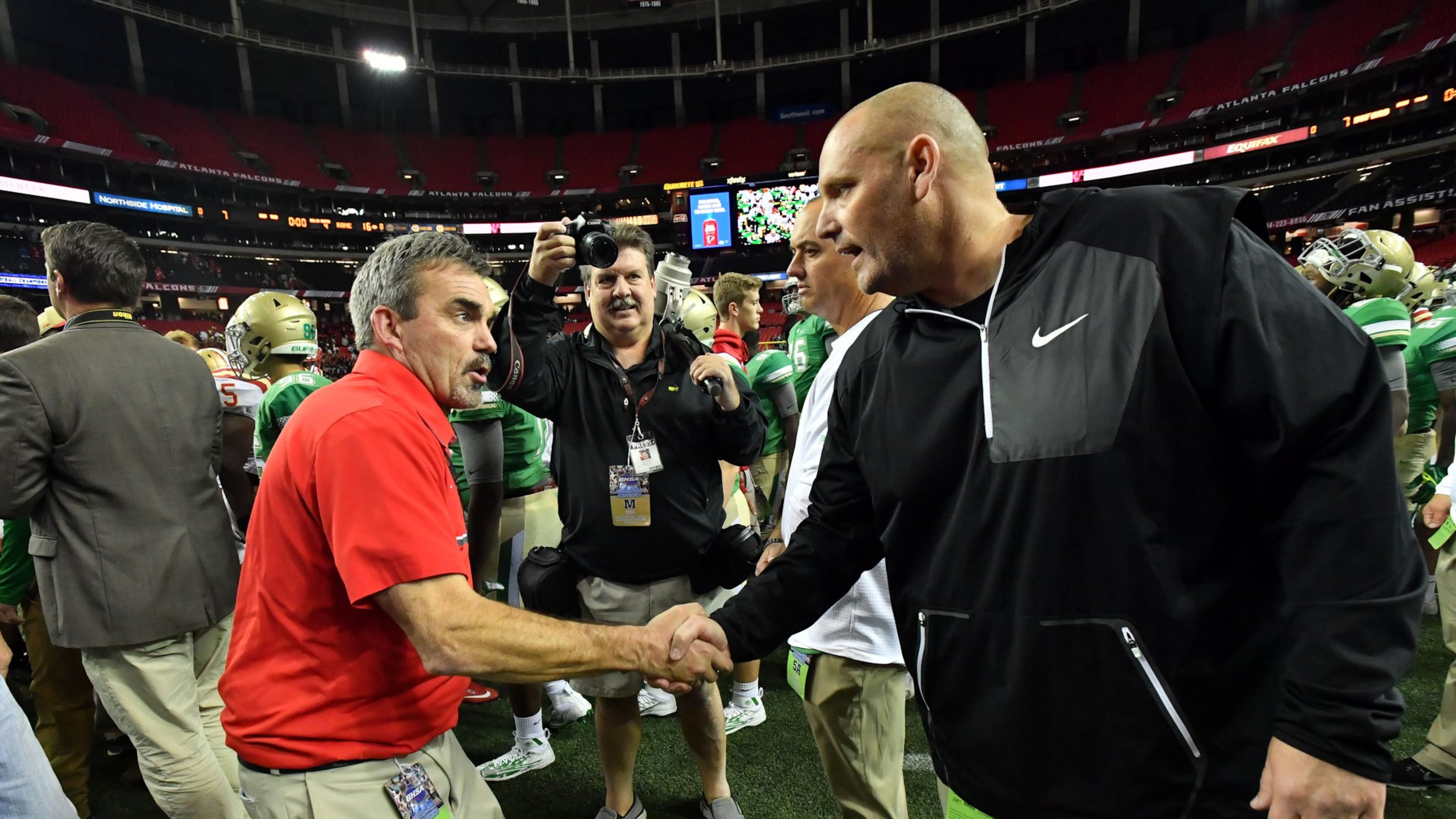 Rome coach John Reid (left) and Buford coach Jess Simpson shake hands after Rome beat Buford during the Class AAAAA state championship game at the Georgia Dome on Friday, December 9, 2016. Rome won 16-7 over the Buford. HYOSUB SHIN / HSHIN@AJC.COM