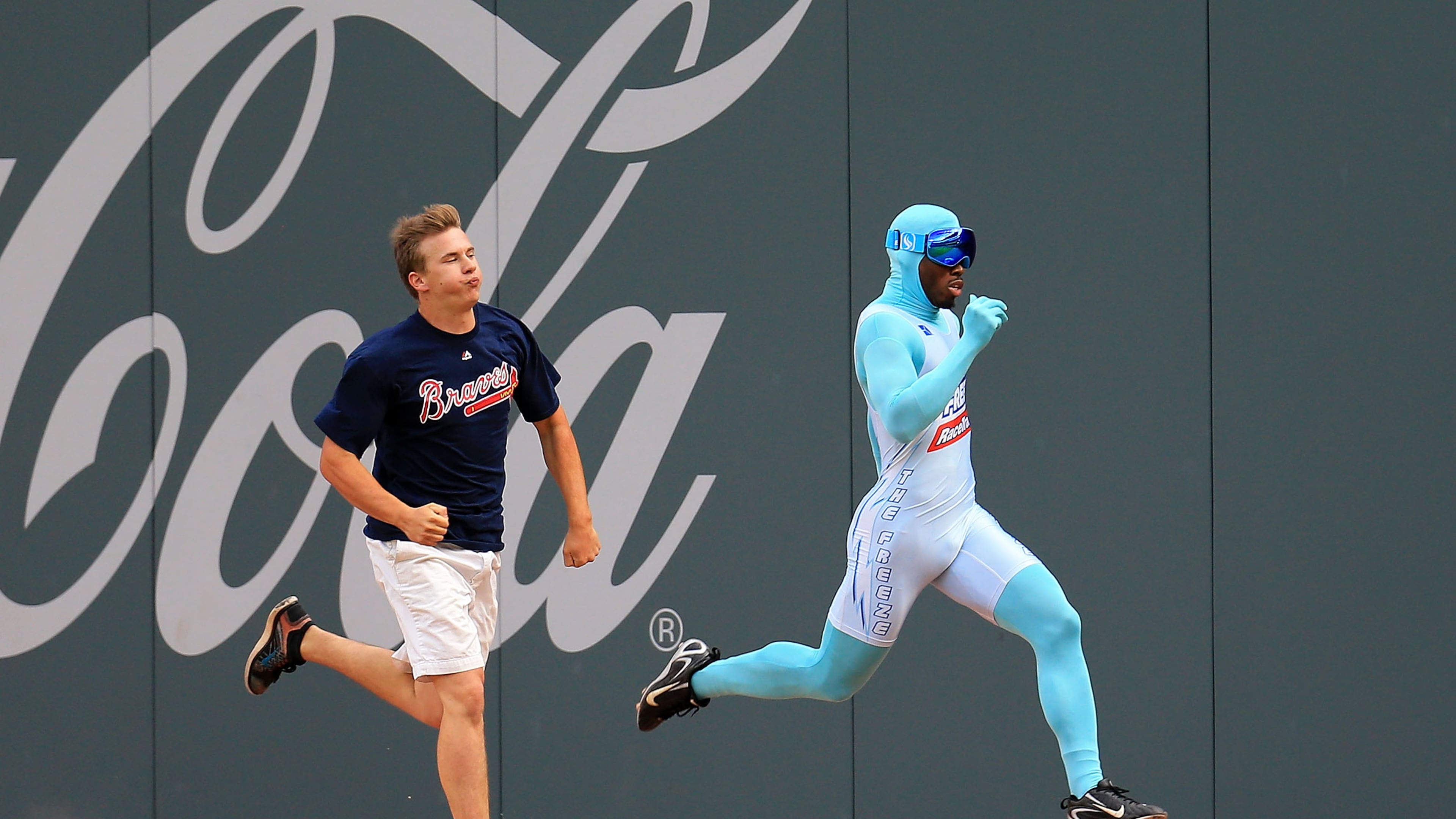 Nigel Talton (right), who was the original "Freeze," races a Braves fan between innings during a game in 2020. (AJC file)