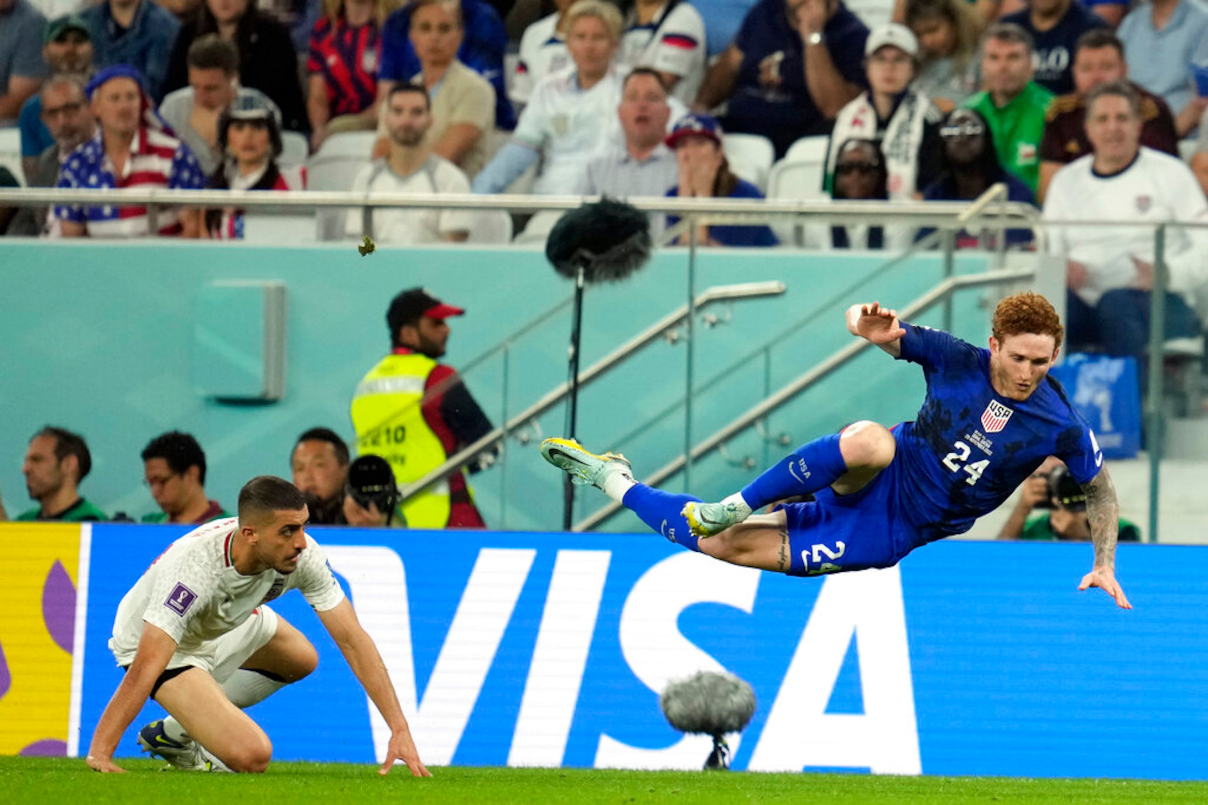 United States' Josh Sargent (24) is upended by Iran's Majid Hosseini during the World Cup group B soccer match between Iran and the United States at the Al Thumama Stadium in Doha, Qatar, Tuesday, Nov. 29, 2022. (AP Photo/Ashley Landis)