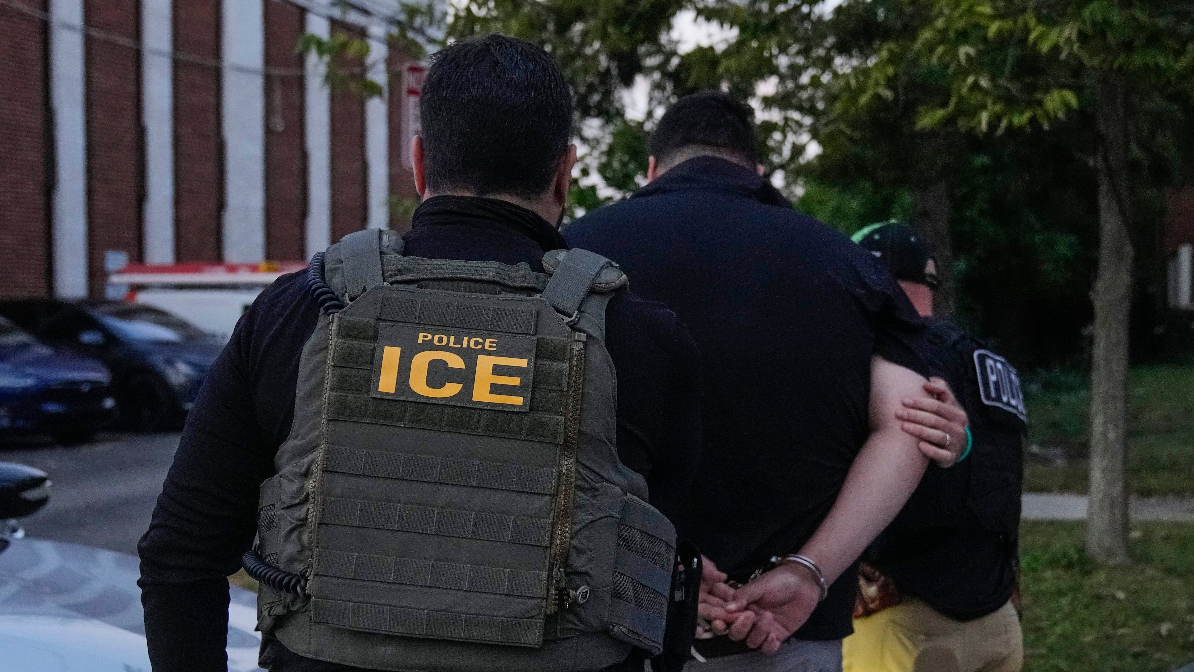 FILE - U.S. Immigration and Customs Enforcement agents make an arrest during an early morning operation in Park Ridge, Ill., Sept. 19, 2025. (AP Photo/Erin Hooley, File)