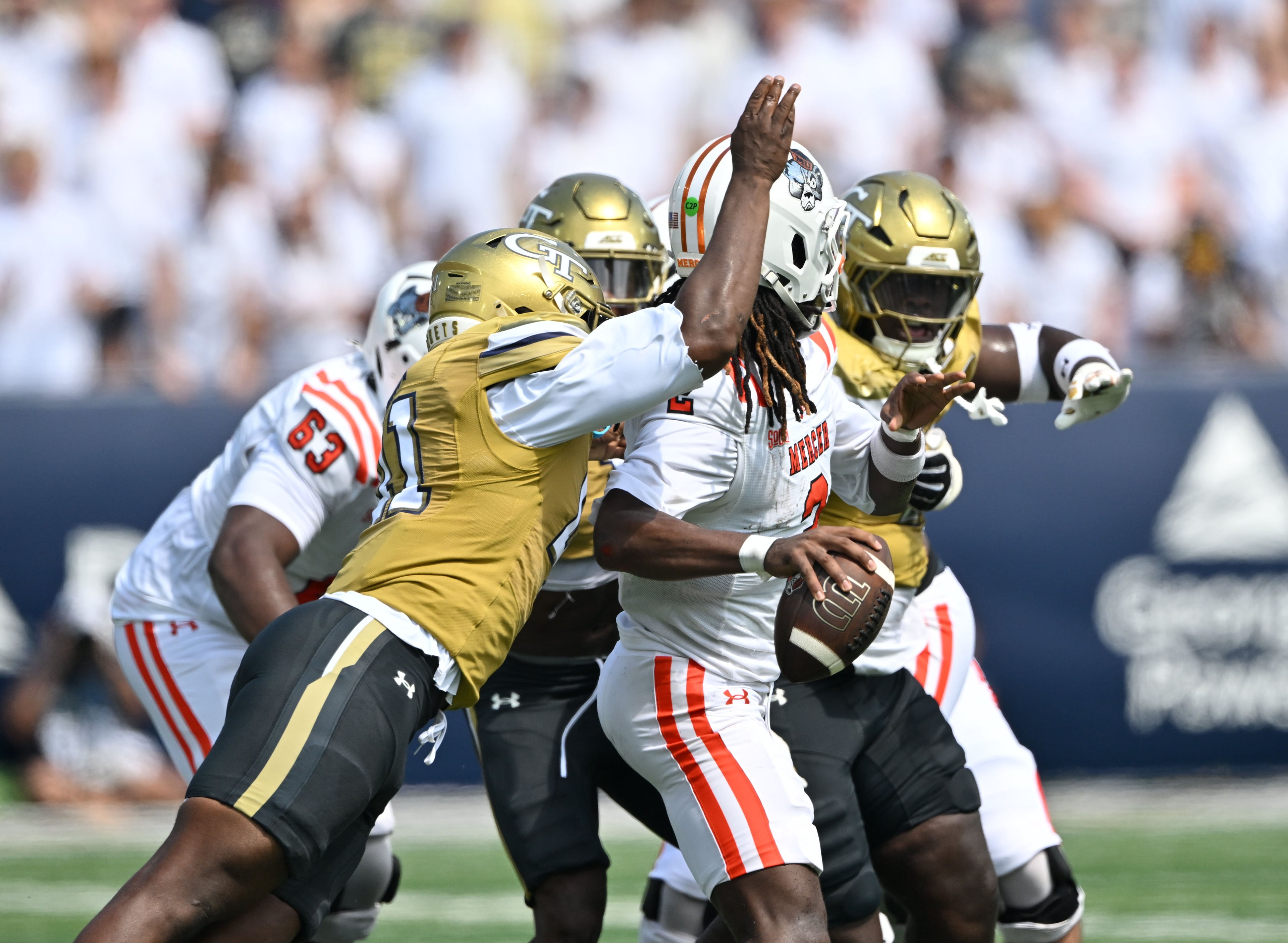 Mercer quarterback Jaylen King (2) is hit by Georgia Tech defensive end Taje McCoy (left) causing a fumble during the first half in an NCAA college football game at Bobby Dodd Stadium on Saturday, Sept. 19, 2026, in Atlanta. (Hyosub Shin/AJC)