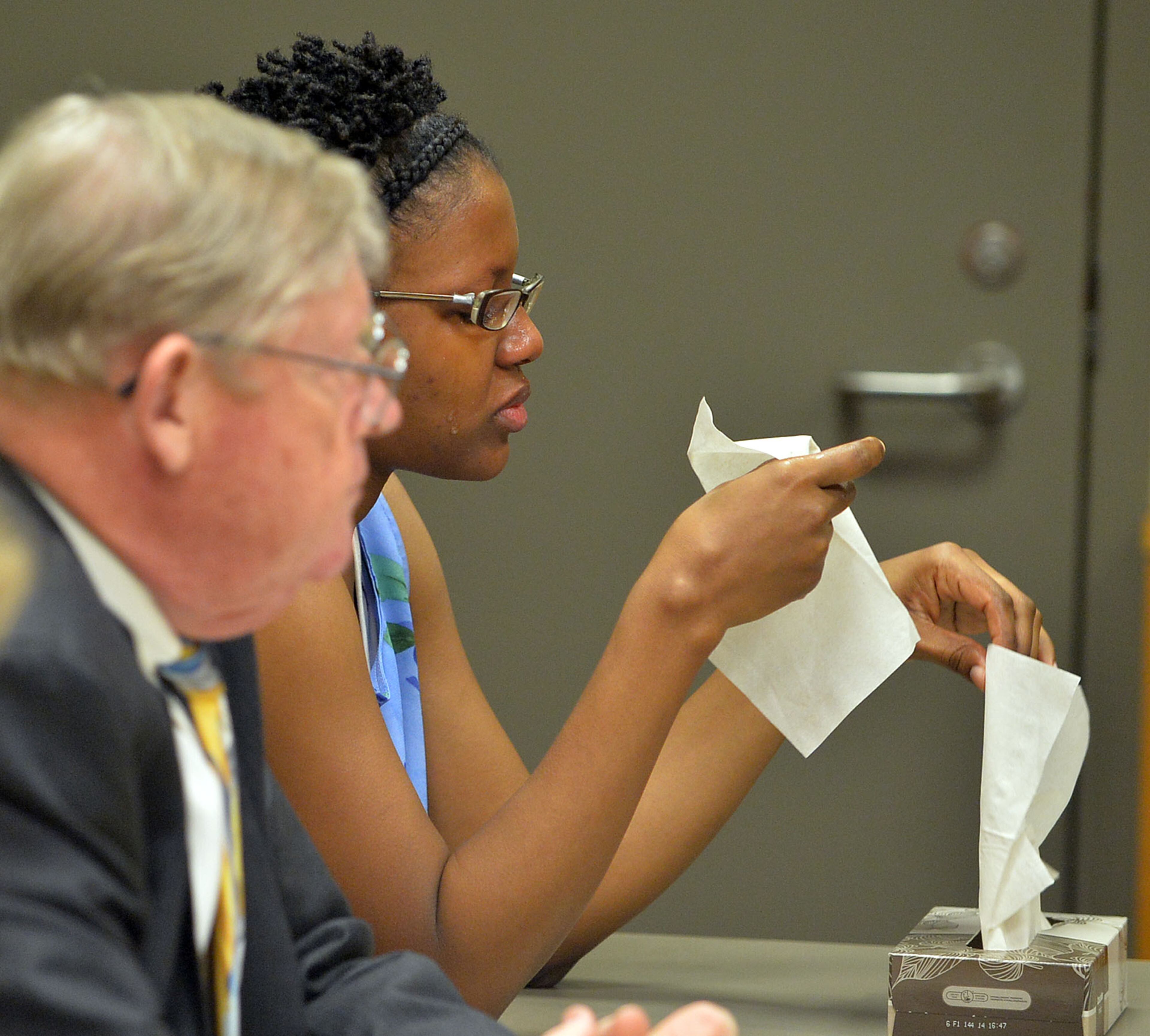 Najlaa Mcintosh becomes emotional during testimony by GCPD Detective James Sweeney. Chief Magistrate Kristina Hammer Blum presides over hearing for a Gwinnett man and his daughter who are charged with starving the man's child to death and withholding food from the child's 21-year-old mother, who weighed 59 pounds when she was found. Calvin Mcintosh and his daughter, Najlaa, appear in the probable cause hearing Friday, December 5, 2014. Judge Blum found there was probably cause for cruelty to children and murder charges and bound their case over to Superior Court. She said that due to the charges, the court did not have jurisdiction to set a bond. KENT D. JOHNSON/KDJOHNSON@AJC.COM