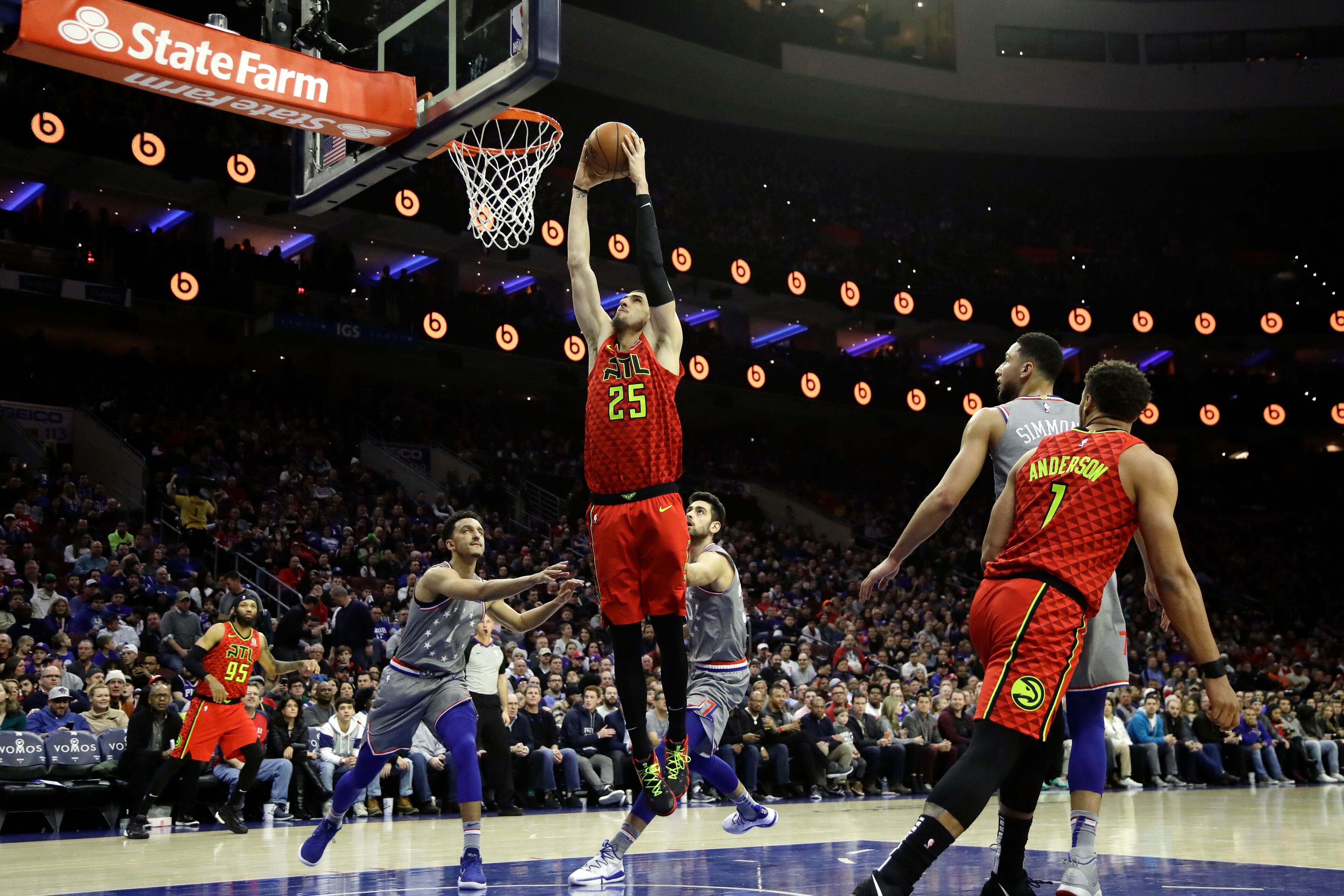 Atlanta Hawks' Alex Len (25) goes up for a dunk past Philadelphia 76ers' Landry Shamet (1) and Furkan Korkmaz (30) during the first half of an NBA basketball game Friday, Jan. 11, 2019, in Philadelphia. (AP Photo/Matt Slocum)