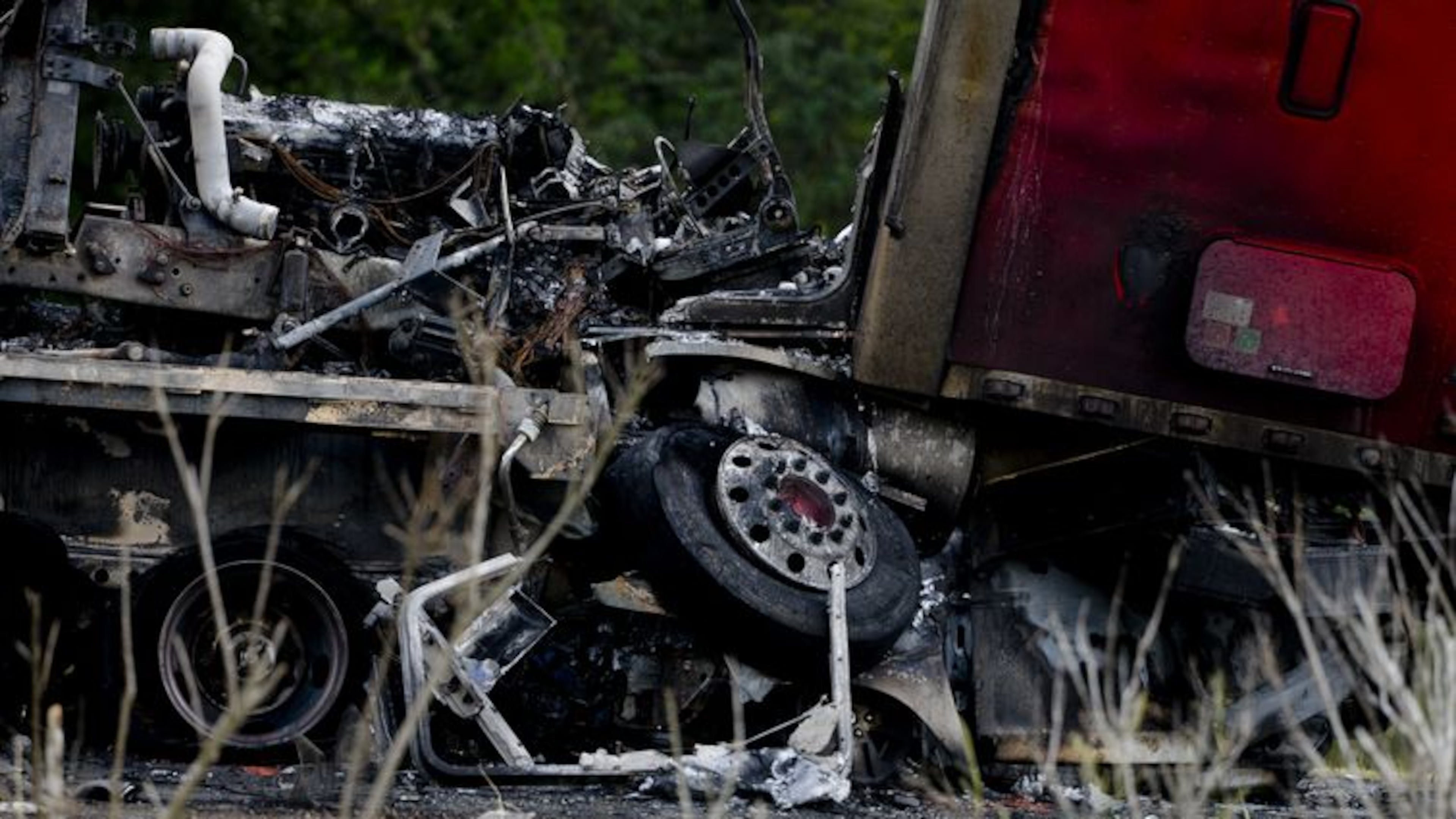 A tractor trailer sits on top of a crushed car after a multiple car accident on I-16 in Pooler, Ga. on Tuesday, May 19, 2015. (Ian Maule/Savannah Morning News via AP)