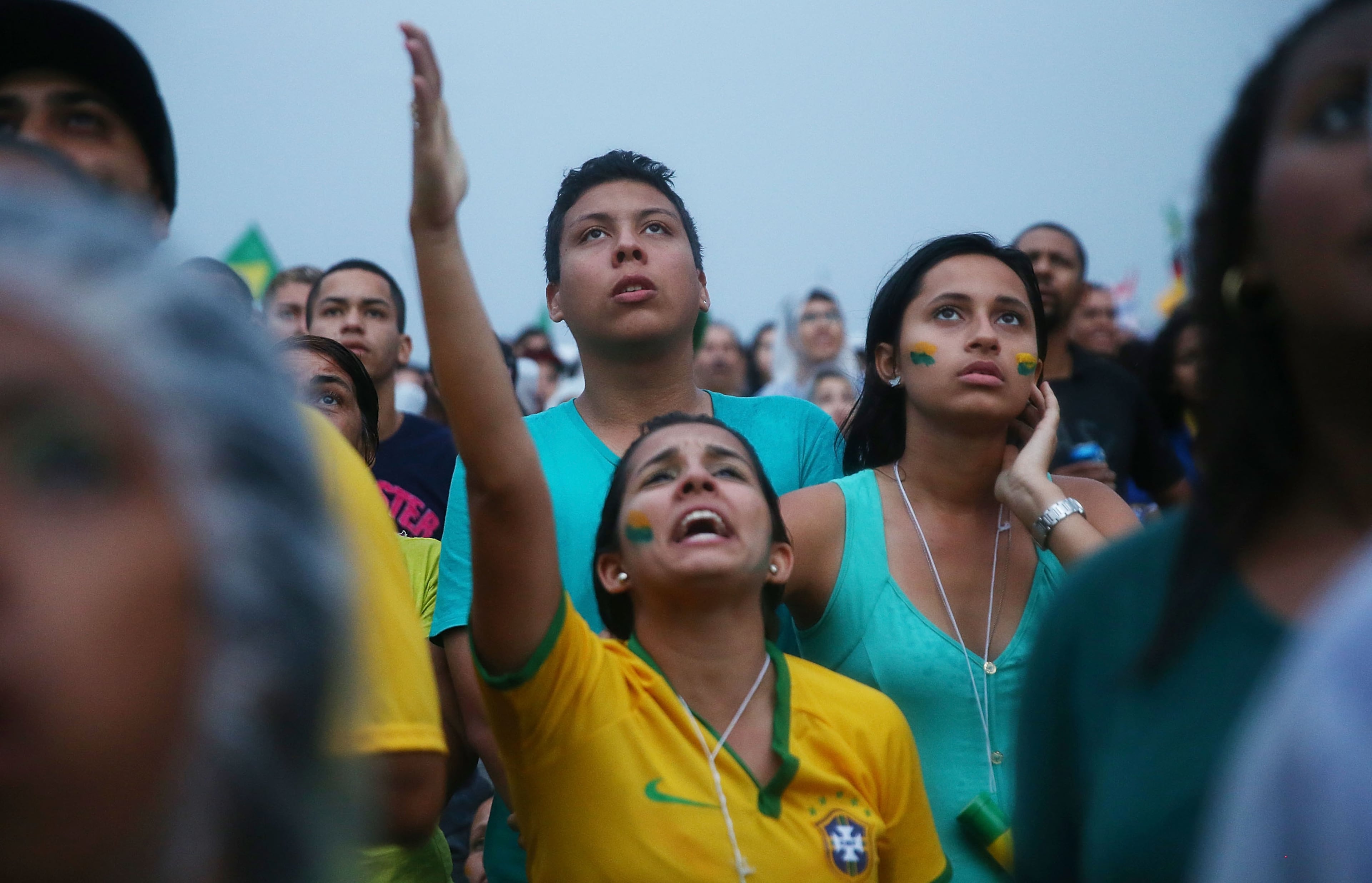 Brazil fans watch the first half on Copacabana Beach during the 2014 FIFA World Cup semifinal match between Brazil and Germany on July 8, 2014 in Rio de Janeiro, Brazil. (Photo by Mario Tama/Getty Images)