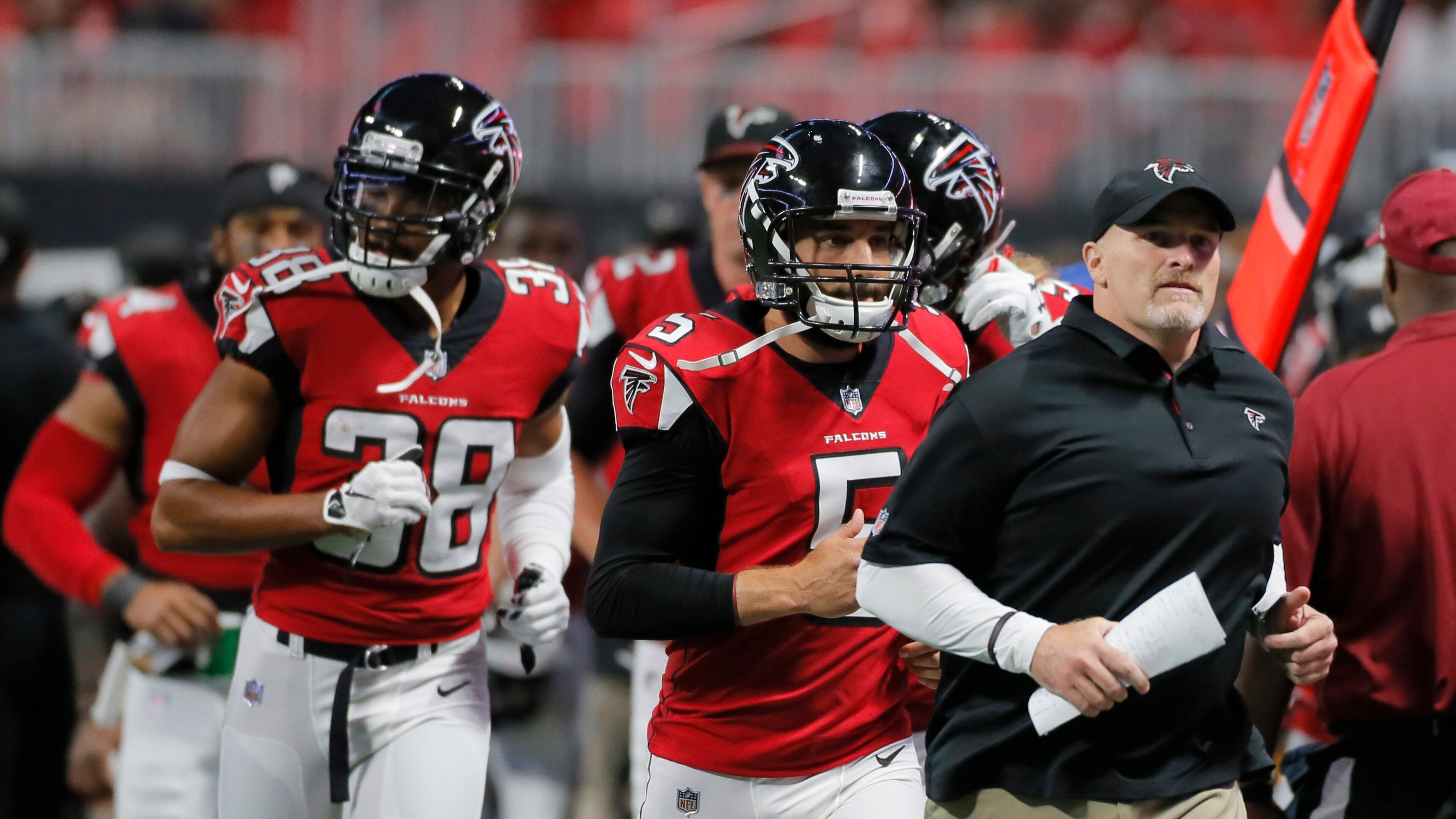 8/26/17 - Atlanta, GA - Coach Dan Quinn leads his team off the field at the half. The first game in Mercedes-Benz Stadium was Saturday, as the Atlanta Falcons played Arizona in an exhibition game.. BOB ANDRES /BANDRES@AJC.COM