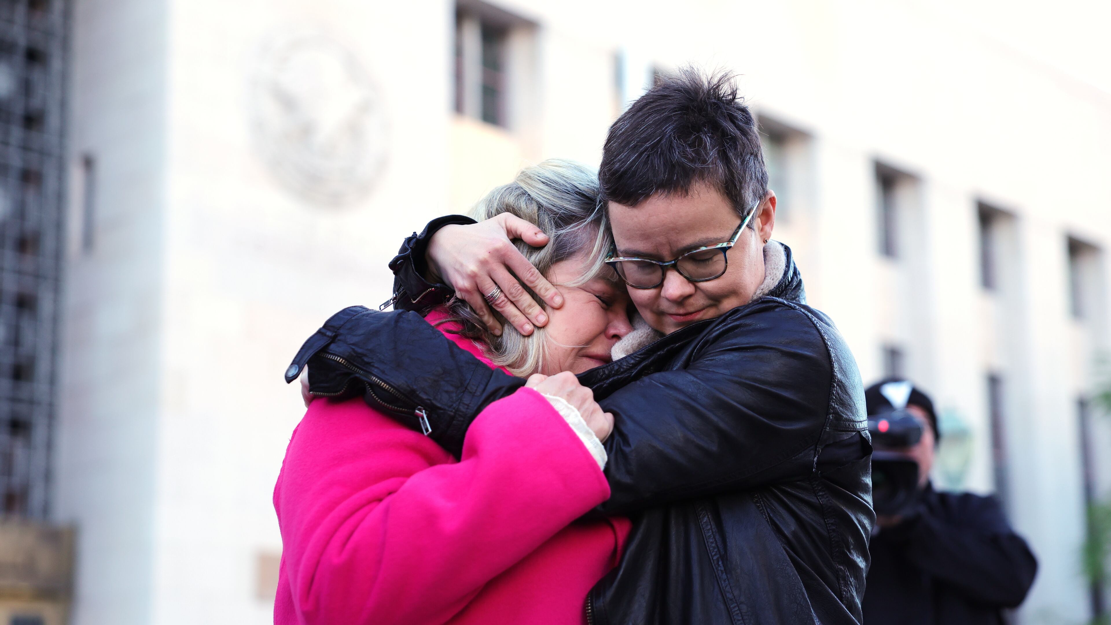 Lennon Flowers, right, Project Director of The Parents' Network hugs Lori Schott, mother of Annalee Schott, outside a landmark trial over whether social media platforms deliberately addict and harm children, Wednesday, Feb. 18, 2026, in Los Angeles. (AP Photo/Ryan Sun)