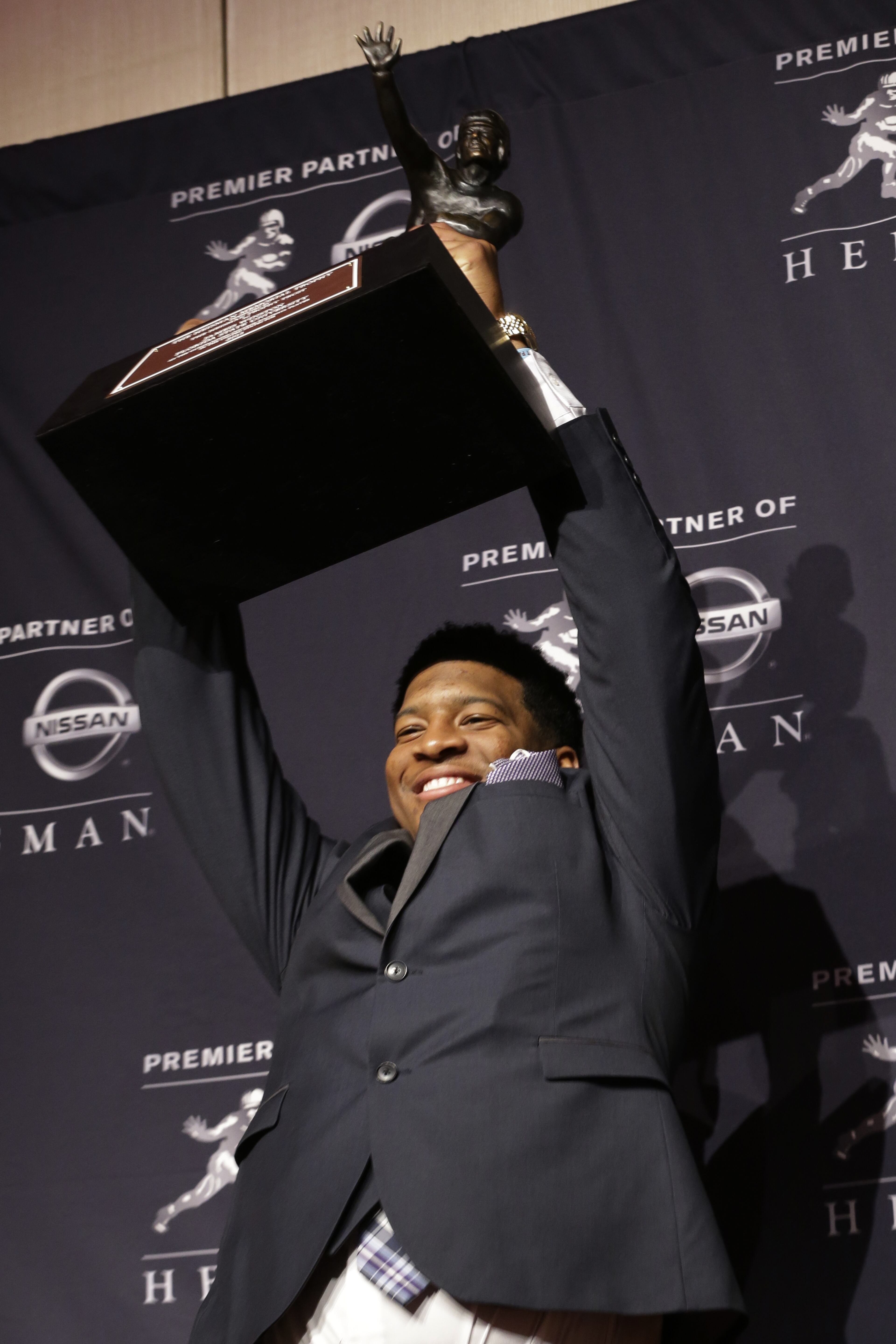 Florida State quarterback Jameis Winston poses for photographers with the Heisman Trophy after winning the award, Saturday, Dec. 14, 2013, in New York. Winston becomes the 79th winner of the trophy and is the third player out of Florida State to win the award.