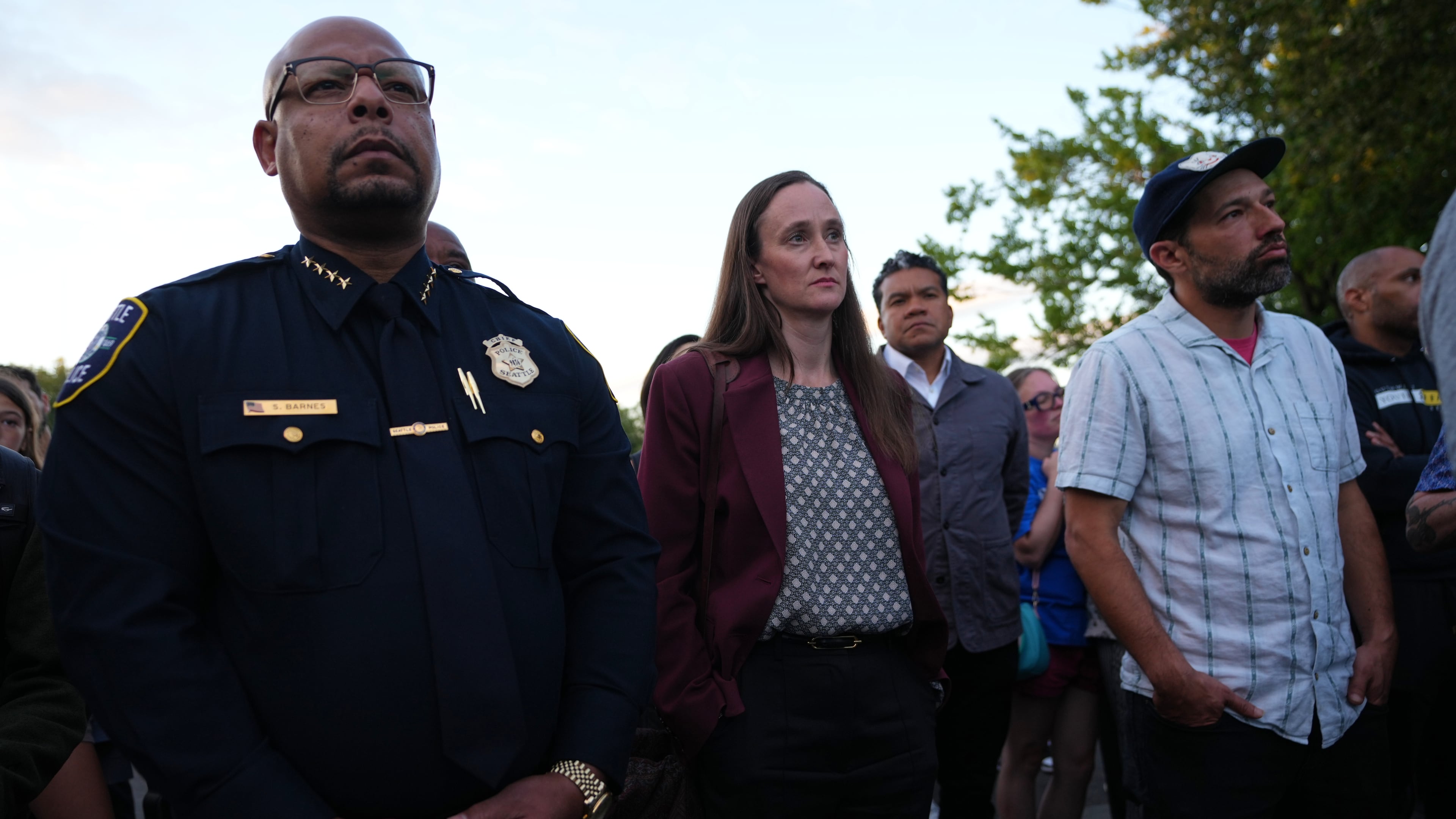 Seattle Mayor Katie Wilson, center, and Seattle Police Chief Shon Barnes, left, attend the vigil for victims the day after a shooting at Seattle Center during the Bite of Seattle food festival, Monday, July 27, 2026, in Seattle. (AP Photo/Lindsey Wasson)