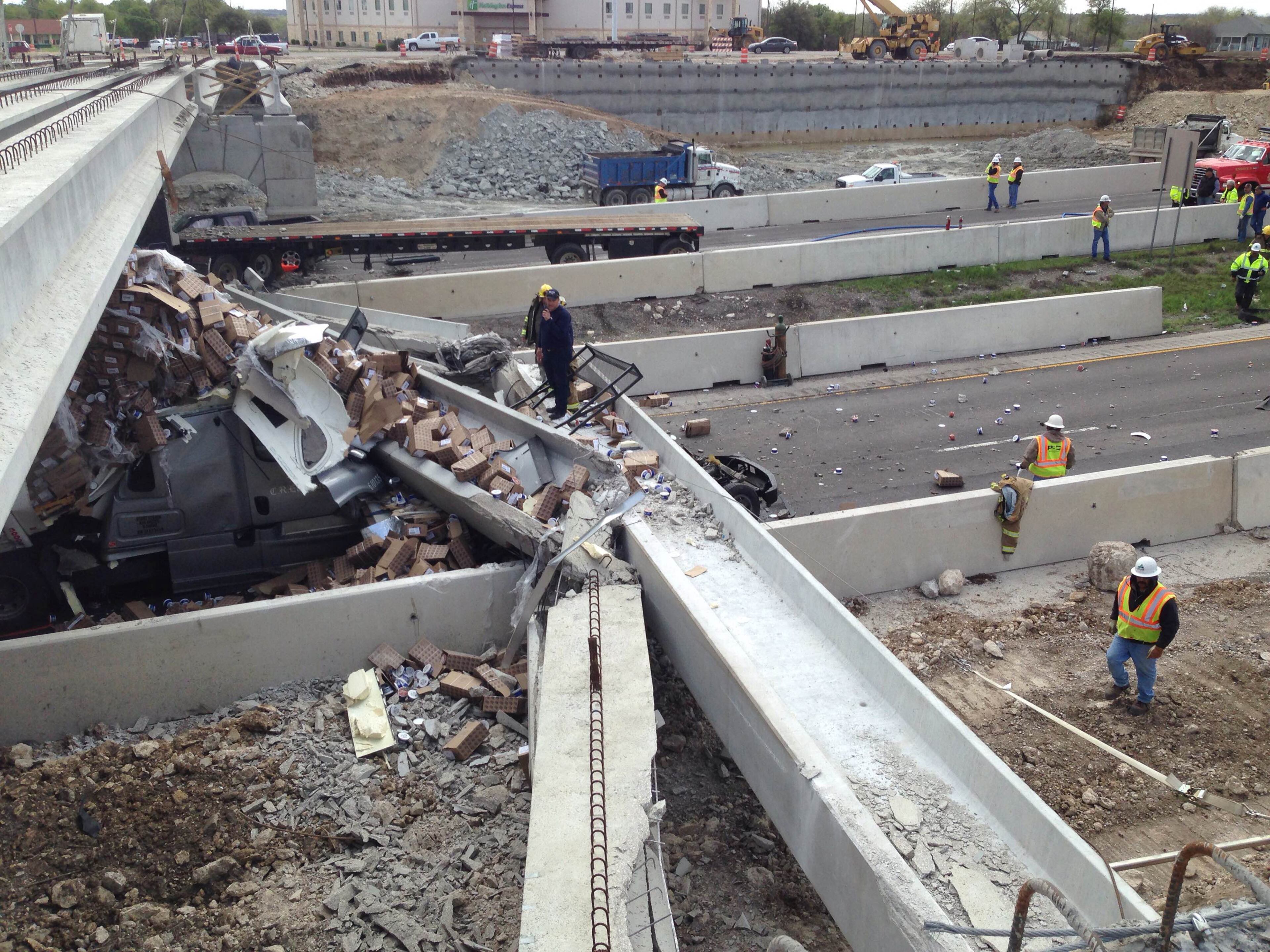 Authorities investigate a tractor-trailer that crashed into an overpass under construction on Thursday, March 26, 2015 in Salado, Texas. Department of Transportation spokeswoman Becky Ozuna says the truck hit a beam being used to build a bridge across Interstate 35 on Thursday morning in Salado, about 40 miles north of Austin. She says several beams then toppled onto other vehicles. Department of Public Safety spokesman Trooper D.L. Wilson says one person was killed and other people were injured, but he didn't immediately have further details. (AP Photo/The Killeen Daily Herald, Clay Thorp)