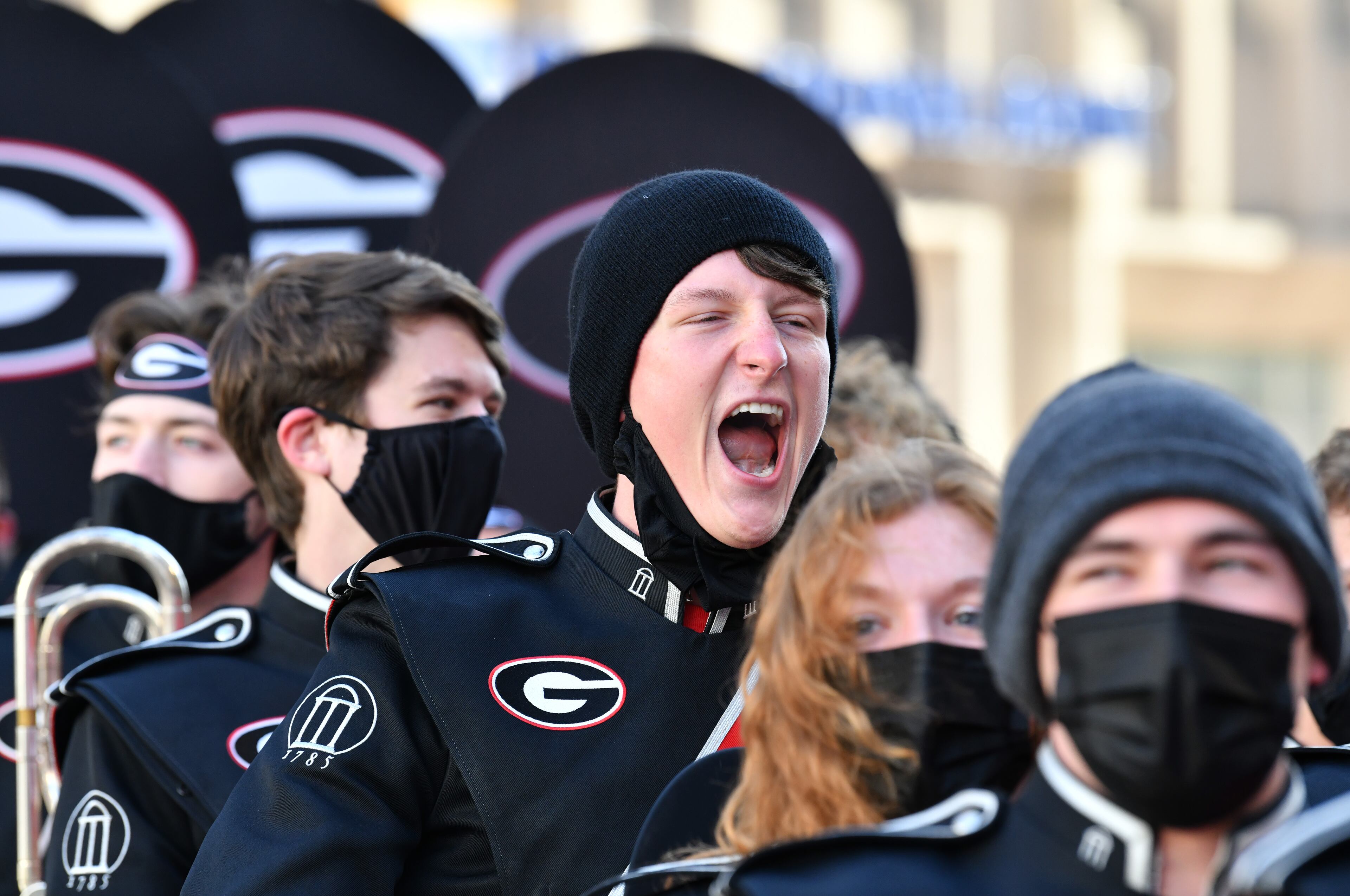 A member of Georgia Redcoat Marching Band shouts and cheers as they march to Monument Circle for Allstate Championship Tailgate prior to the 2022 College Football Playoff National Championship Game at Lucas Oil Stadium in Indianapolis on Monday, January 10, 2022. (Hyosub Shin / Hyosub.Shin@ajc.com)
