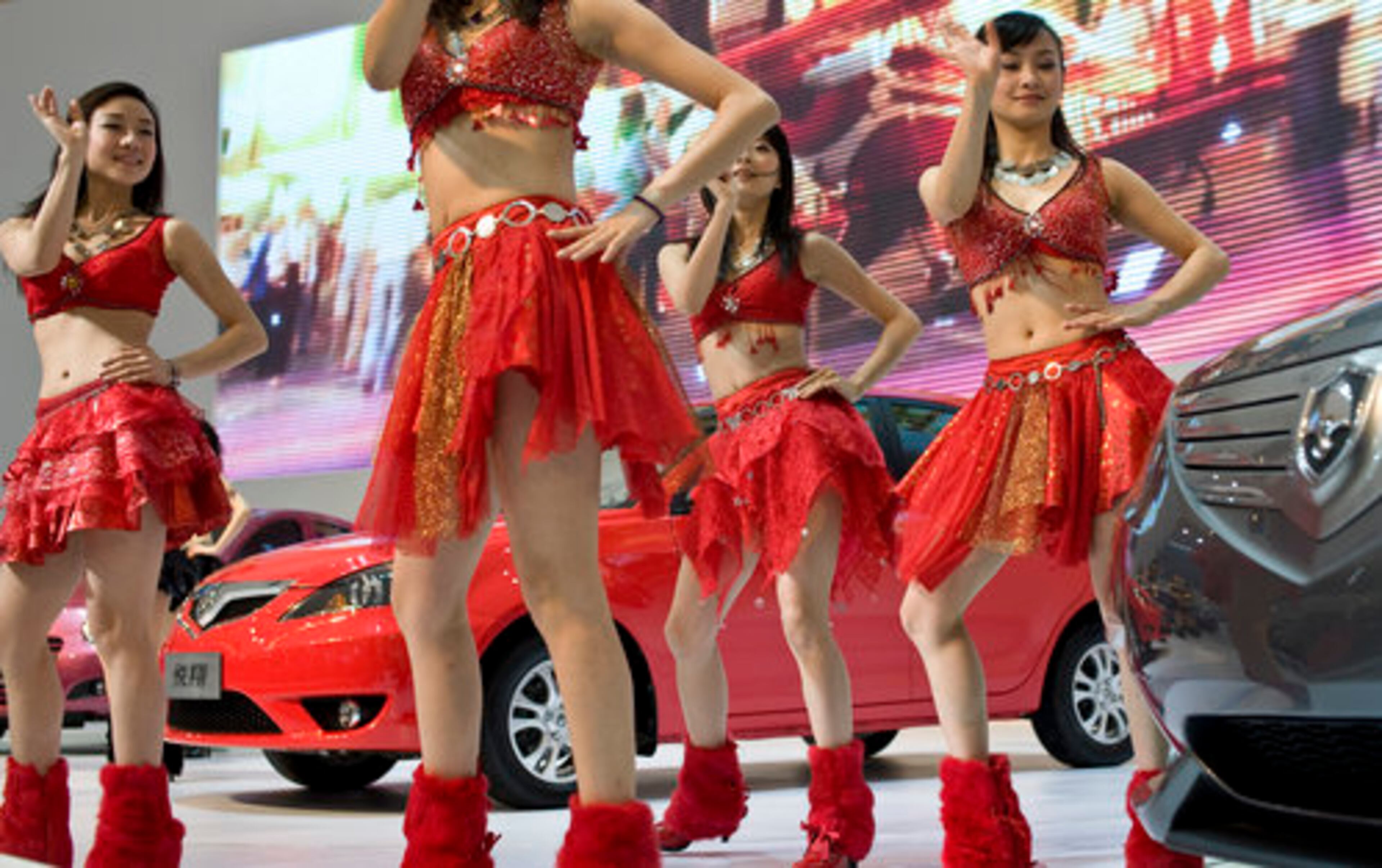 Both domestic and foreign manufacturers have been expanding their product offerings to span the spectrum from lower-end compacts to the raciest, plushest luxury models, the prerequisites for success in China's increasingly diverse, hyper-competitive market. Dancers perform near Chang-an automobiles.