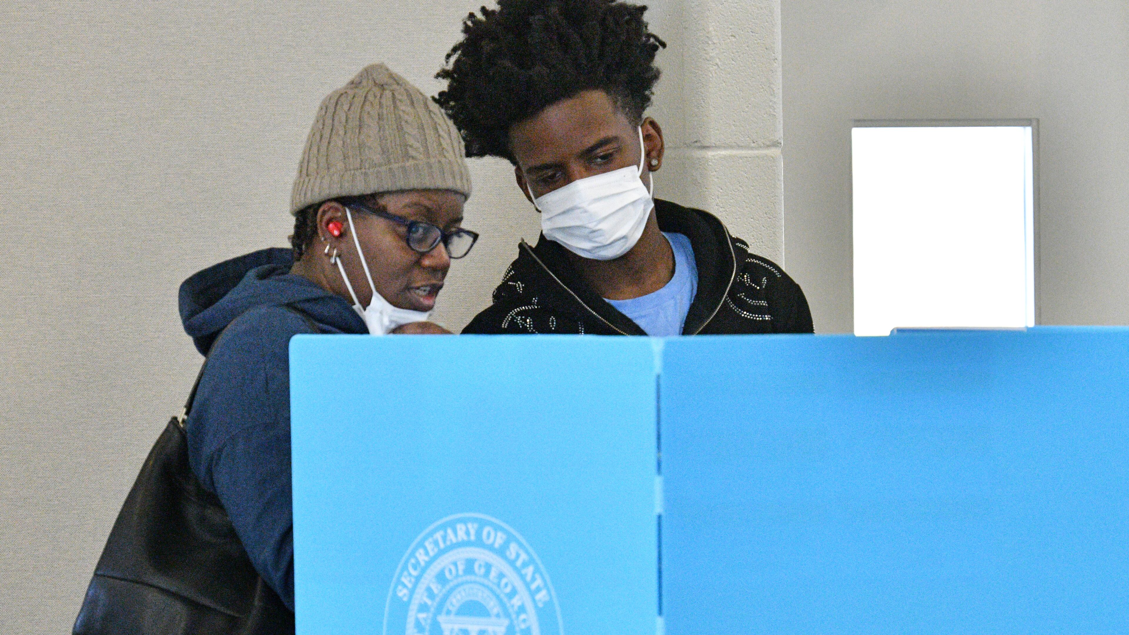 October 22, 2022 Stone Mountain - Linda Settles talks with her son Channing Settles, 18, who is a first time voter, before they cast their ballots at an early voting location in Mountain Park Activity Building in Stone Mountain on Saturday, October 22, 2022. A record-breaking week of early voting continues Saturday, the first weekend voting day of the general election season. Some 729,029 people cast ballots Monday through Friday, far surpassing the 488,177 people voted during the same period in the 2018 midterm election. (Hyosub Shin / Hyosub.Shin@ajc.com)