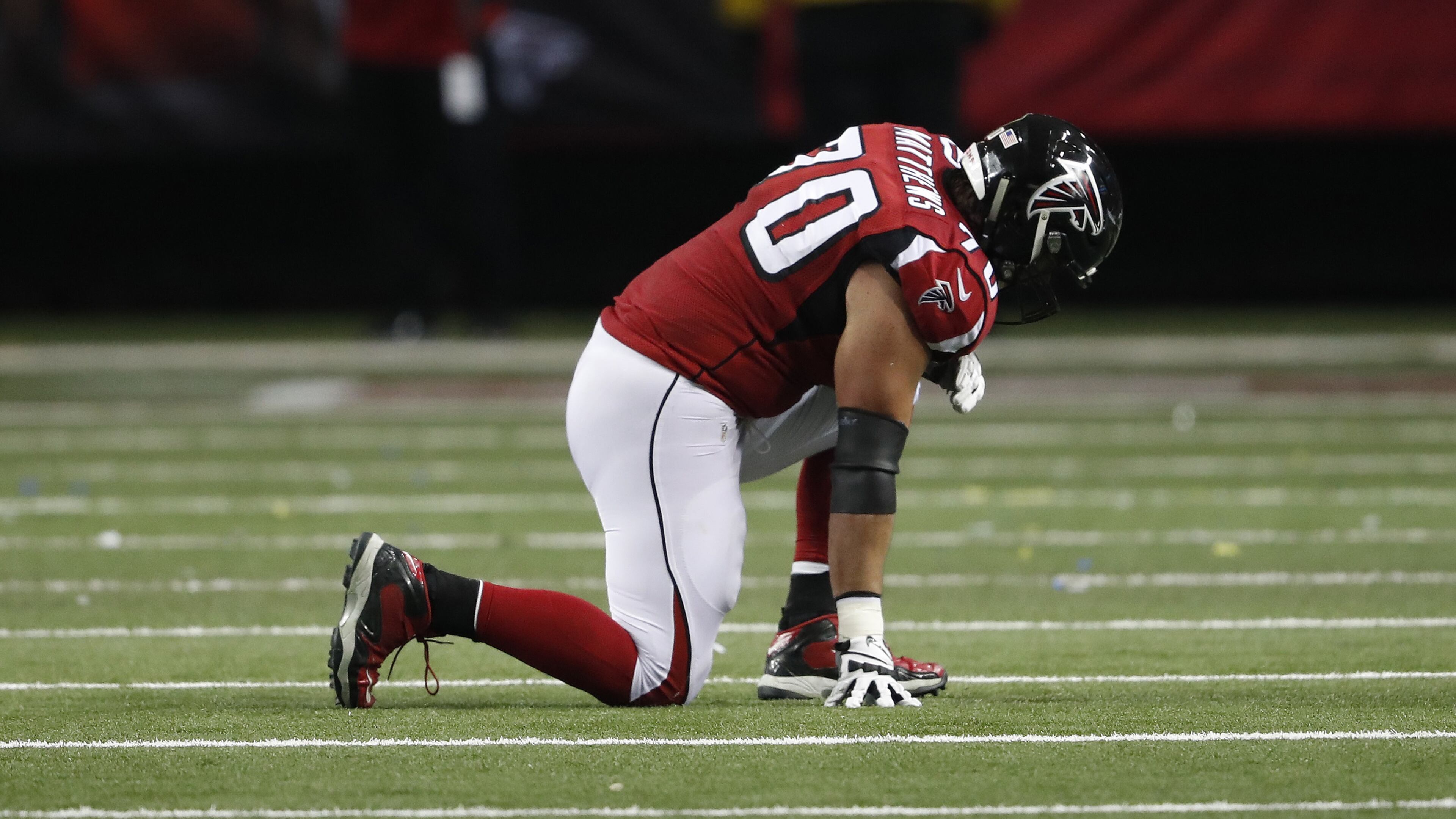 Atlanta Falcons tackle Jake Matthews (70) kneels on the turf after injury against the Kansas City Chiefs during the first half of an NFL football game, Sunday, Dec. 4, 2016, in Atlanta. (AP Photo/John Bazemore)