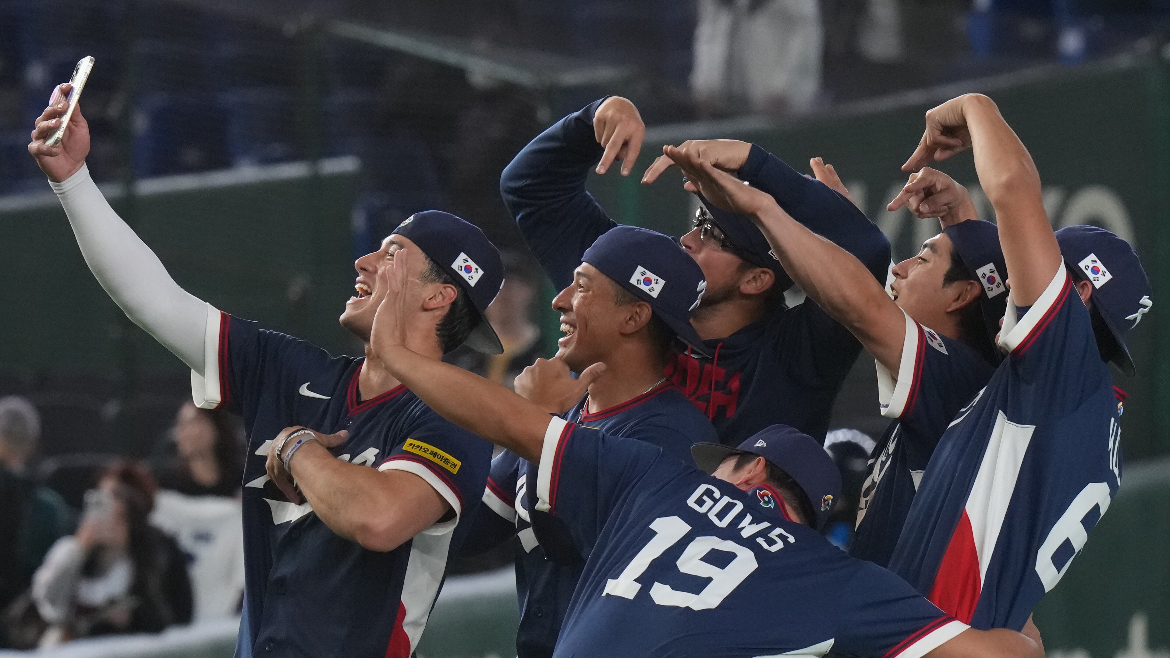 South Korea players take a selfie as they celebrate after defeating Australia in their World Baseball Classic game on Monday, March 9, 2026 in Tokyo. (AP Photo/Eugene Hoshiko)