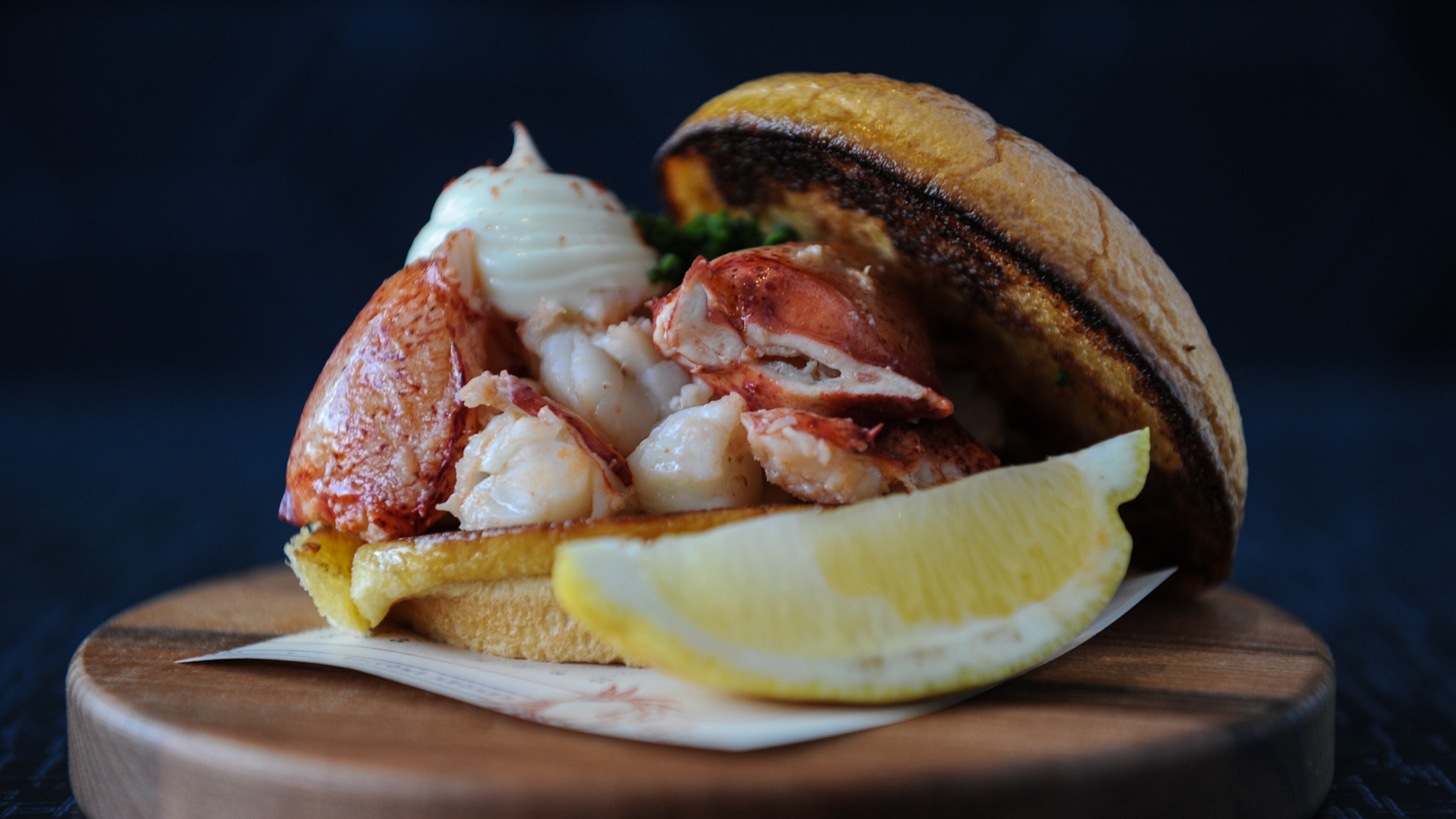 Lobster Roll - whole Maine lobster poached in butter, served warm on a toasted bun.