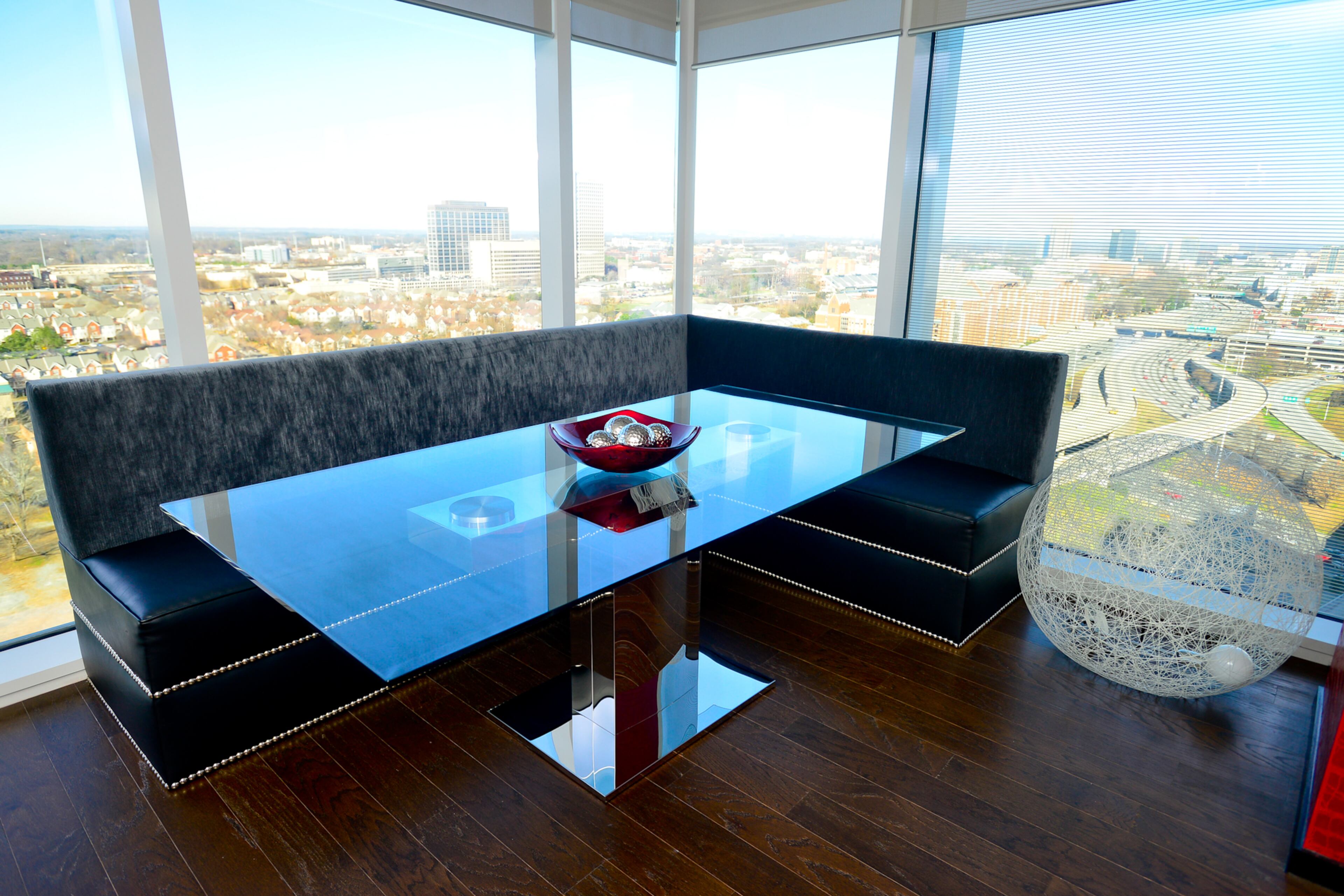 The wide plank hardwood floors weren't changed when Jordan Schafer bought the one-bedroom, two-bath sales center at the Residences at the W Atlanta - Downtown, but he painted the walls a rich red color and gave the condo a modern look. -- Text by Lori Johnston