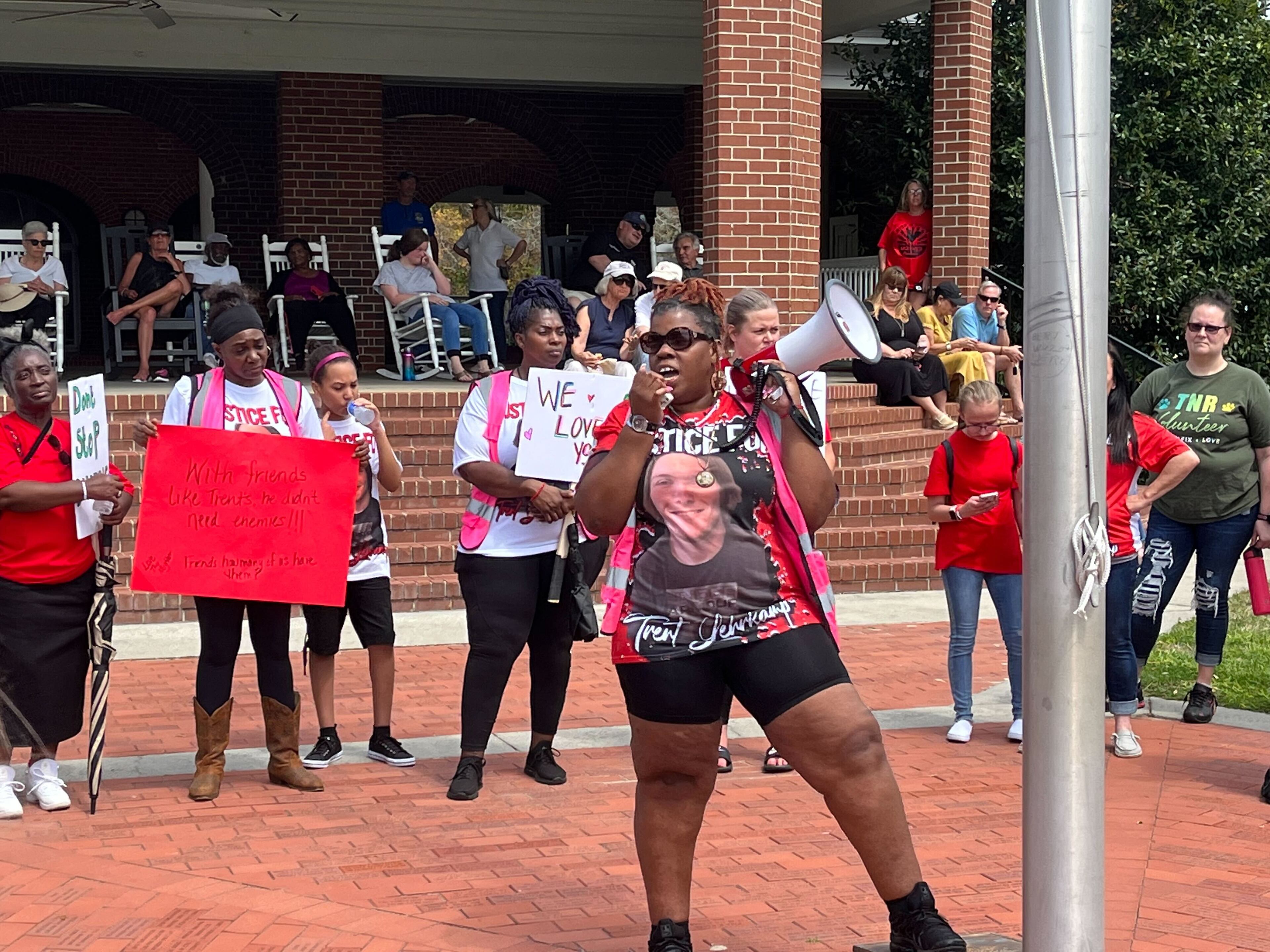 The event was organized by Thea Brooks, who spoke to the crowd with a megaphone.