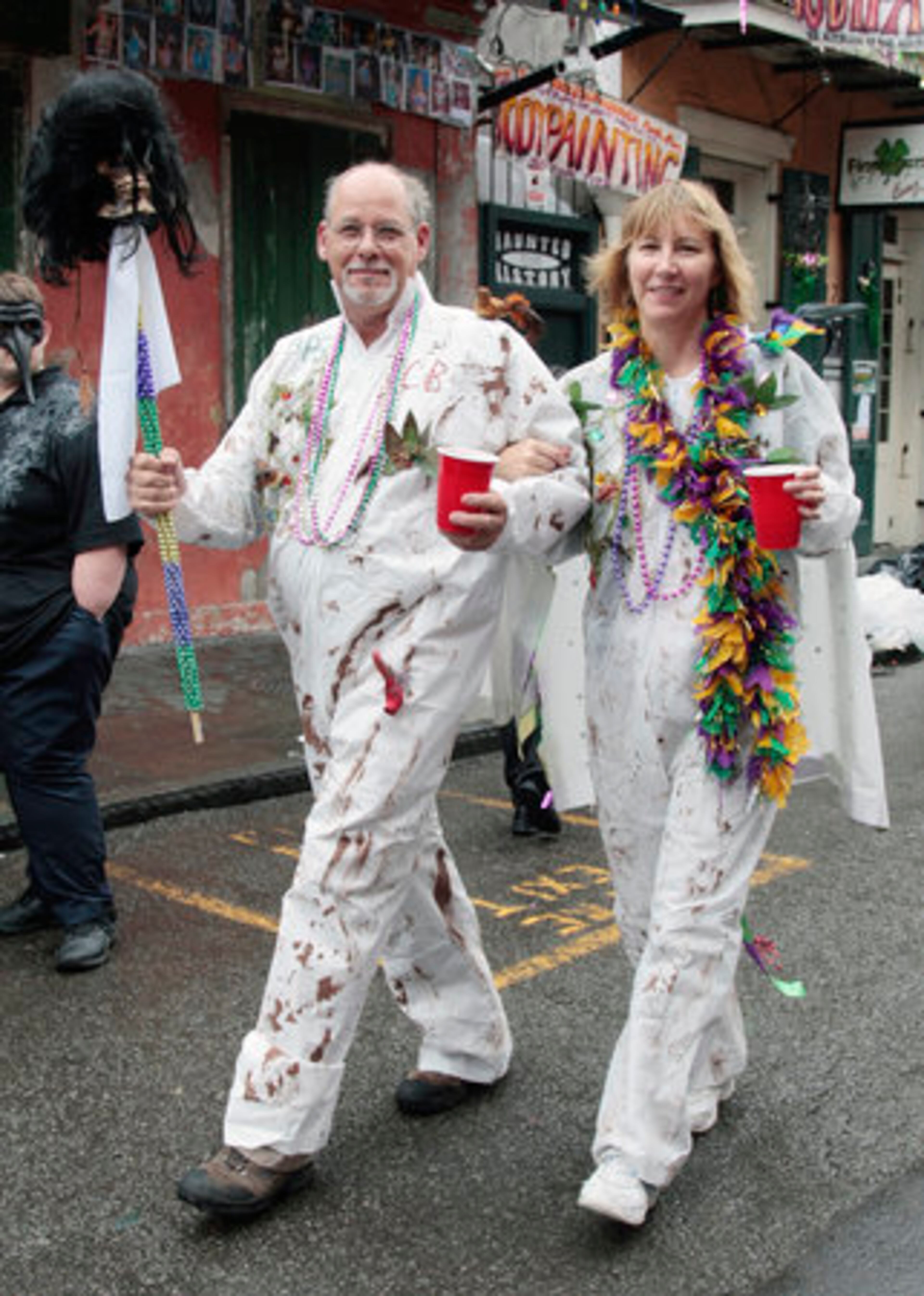 Paul Maudine, of Long Beach, Calif., and his wife Amy, dressed as BP oil spill workers, enjoy Mardi Gras celebrations in the French Quarter.