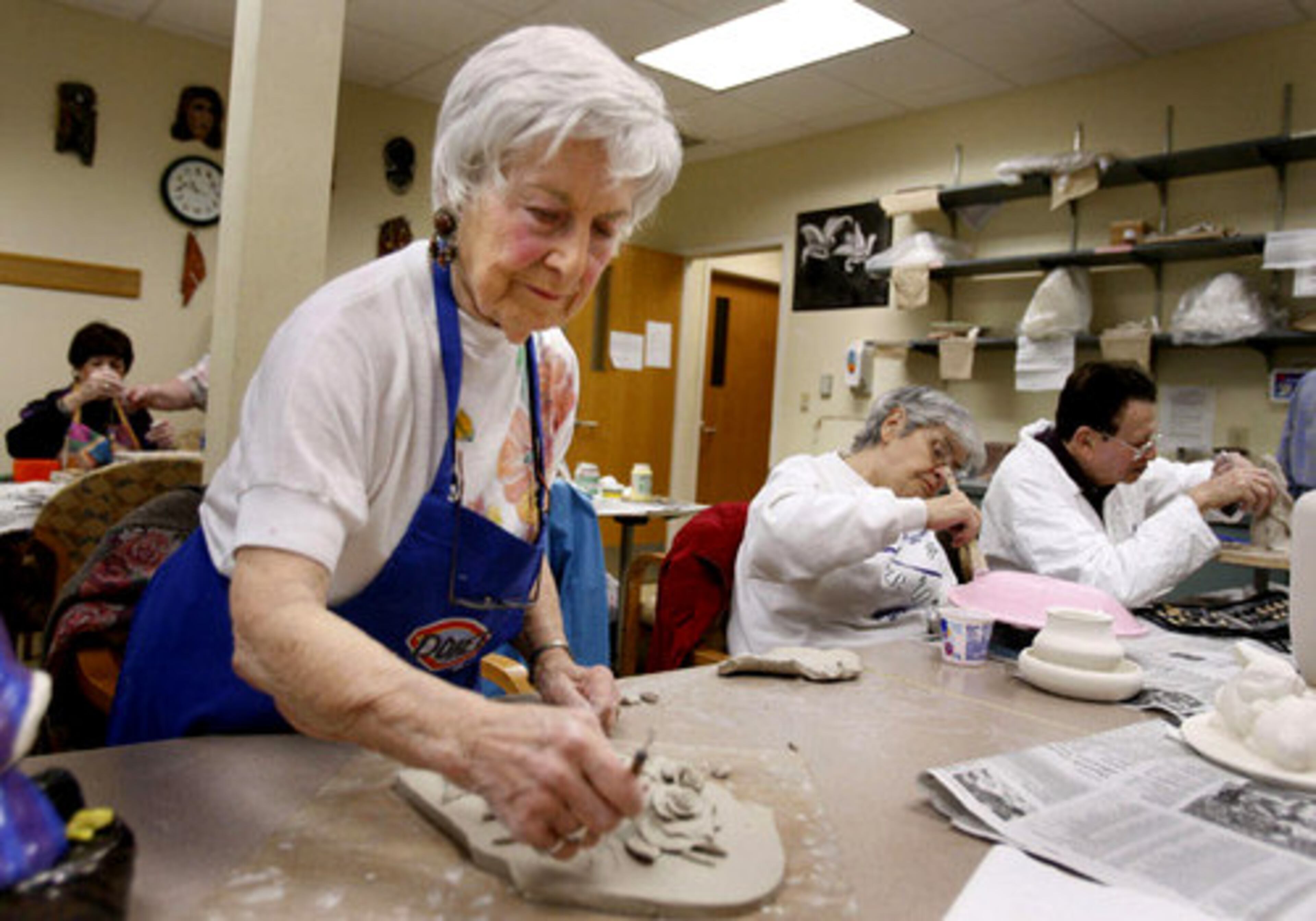 Doree Kemler, Marjorie Rives, 76 and Kermit Cooper, 84, work in clay at a ceramics class at The Dorothy Benson Senior Center in Sandy Springs. Kemler has been attending class for 5 or 6 years.