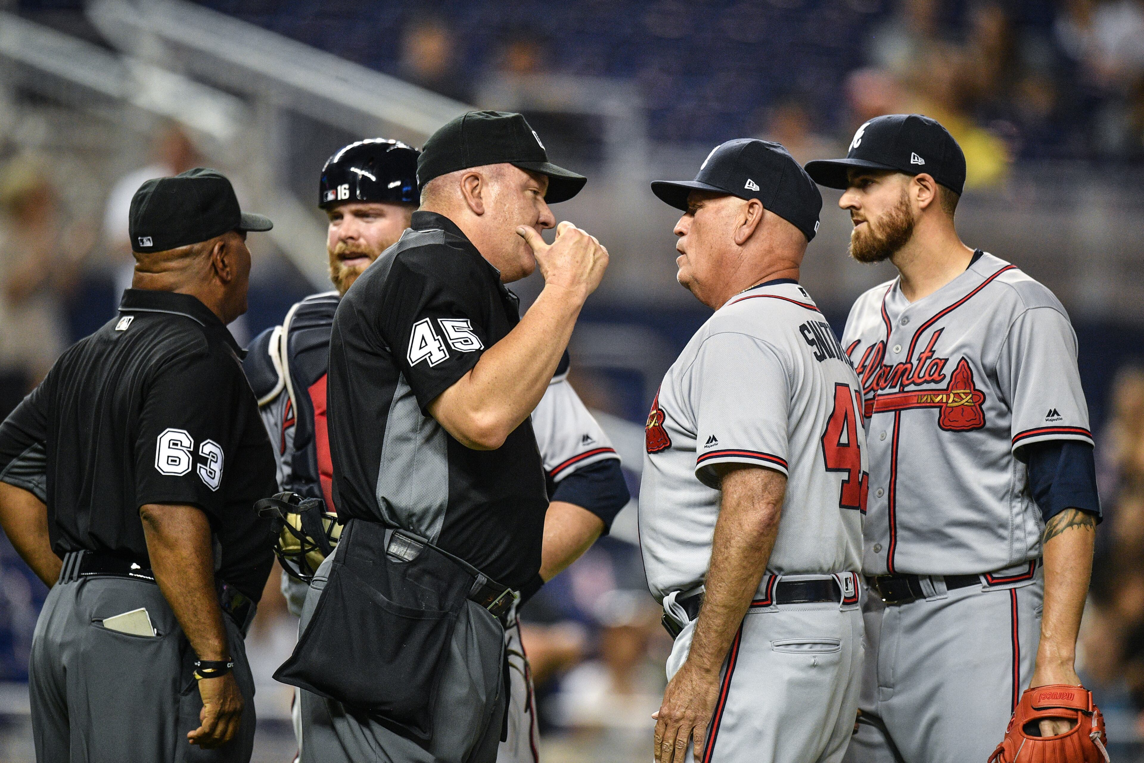 Manager Brian Snitker #43 of the Atlanta Braves argues with umpire Jeff Nelson #45 about ejecting Kevin Gausman #45 of the Atlanta Braves from the game after throwing at Jose Urena #62 of the Miami Marlins in the second inning at Marlins Park on May 3, 2019 in Miami, Florida. (Photo by Mark Brown/Getty Images)