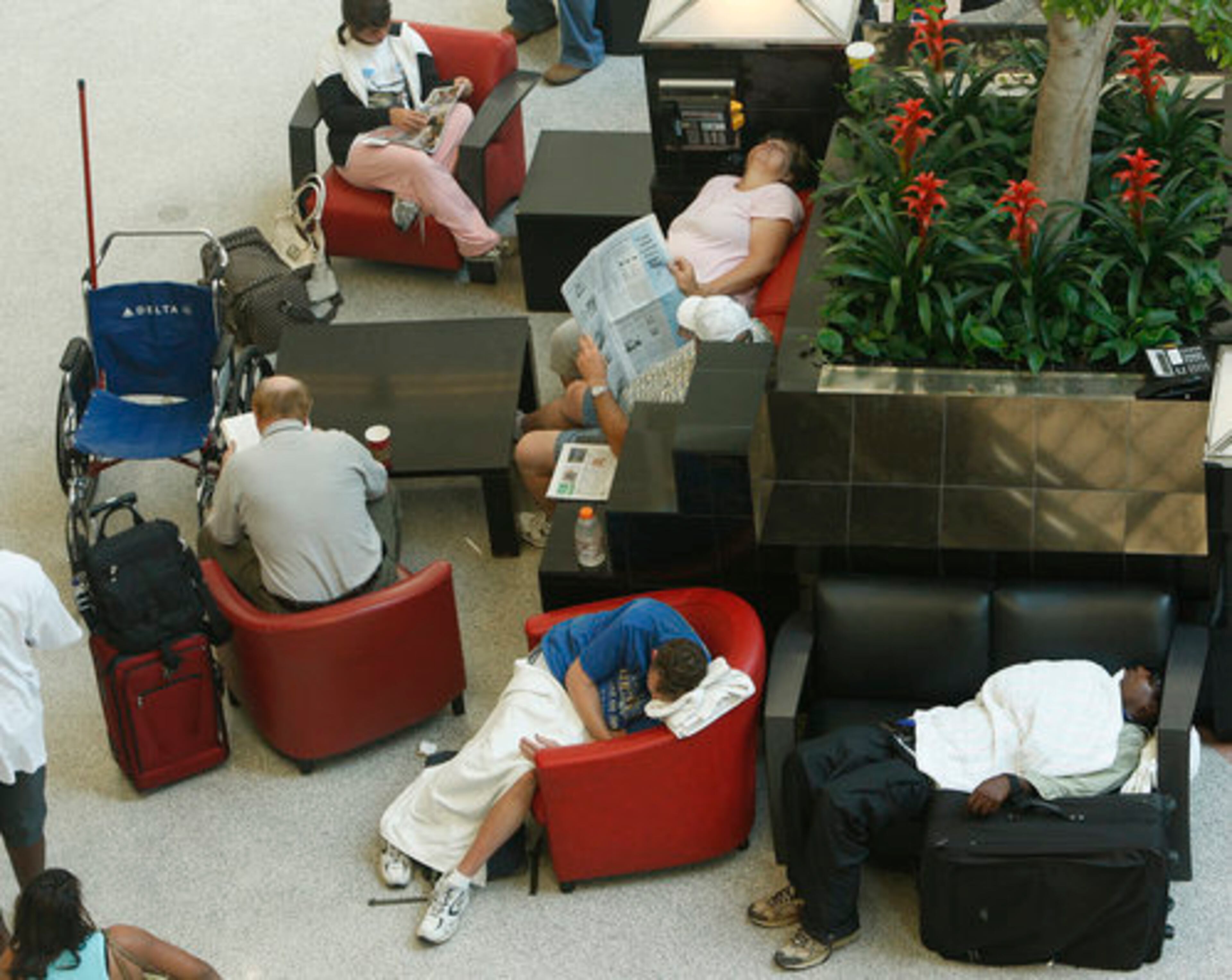 The storm dumped 2.1 inches of rain on the metro area, a record for July 13, according to the National Weather Service. Forecaster Kent McMullen blamed the severe weather on a tropical air mass and a cold front that moved through the state. To deal with the delays Monday, some napped p while others read inside the Atlanta airport's atrium.