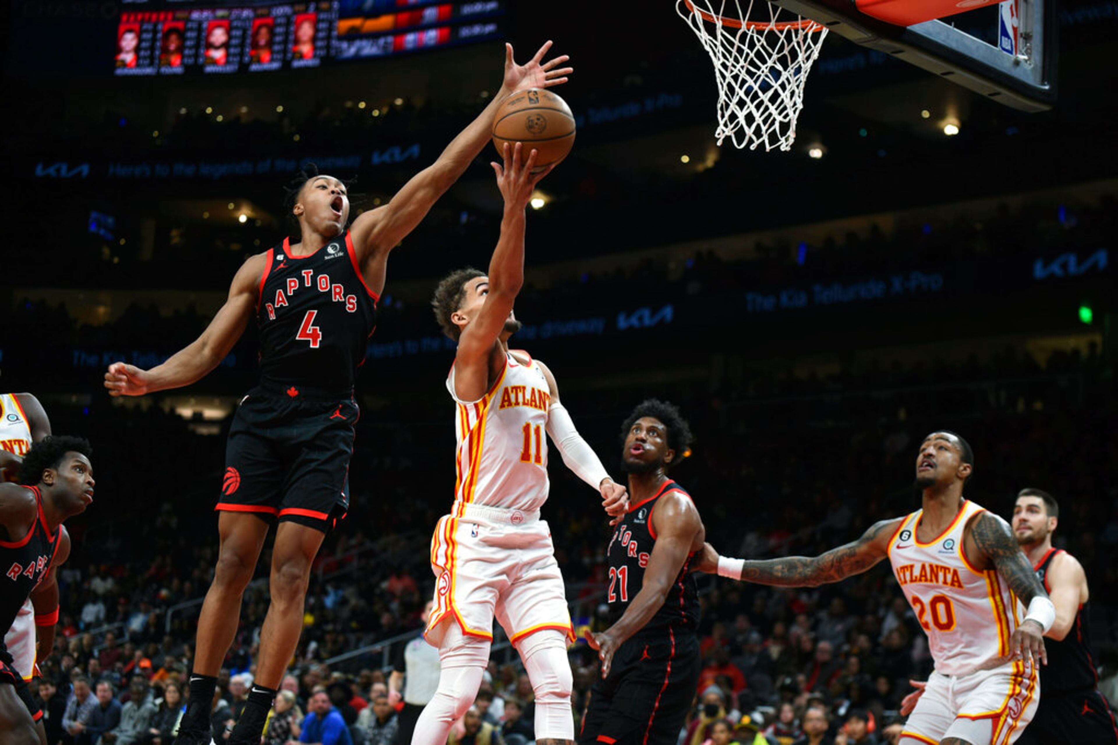 Atlanta Hawks guard Trae Young scores on Toronto Raptors forward Scottie Barnes during the first half of an NBA basketball game, Saturday, Nov. 19, 2022, in Atlanta. (AP Photo/Hakim Wright Sr.)