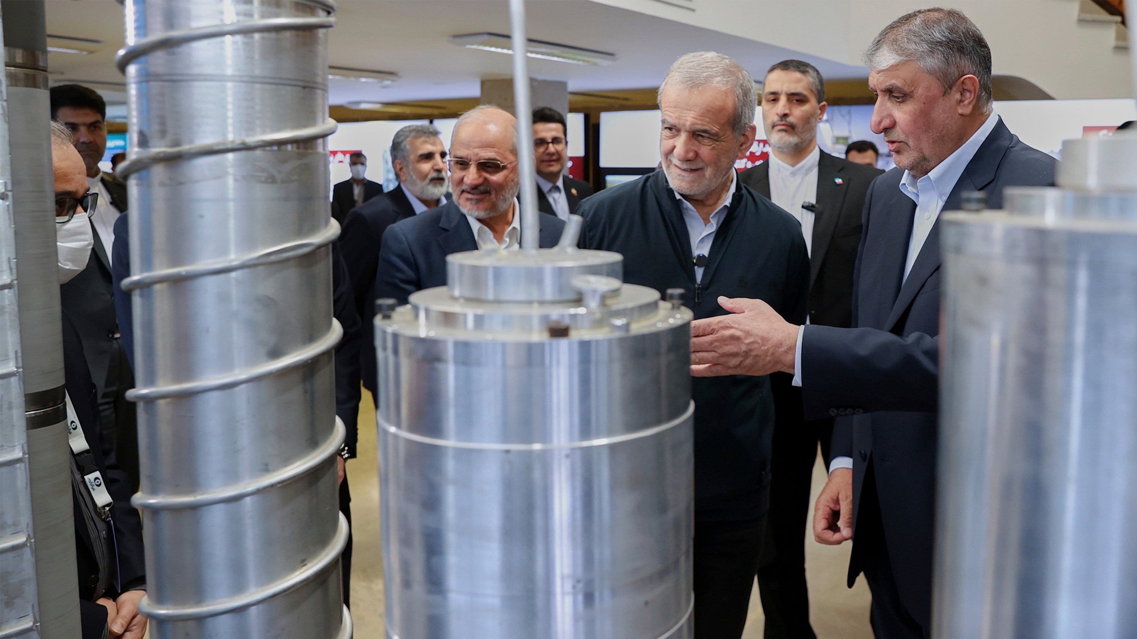 FILE - In this photo released by the Iranian Presidency Office, President Masoud Pezeshkian, second right, listens to head of Atomic Energy Organization of Iran Mohammad Eslami as he visits an exhibition of Iran's nuclear achievements, in Tehran, Iran, April 9, 2025. (Iranian Presidency Office via AP, File)