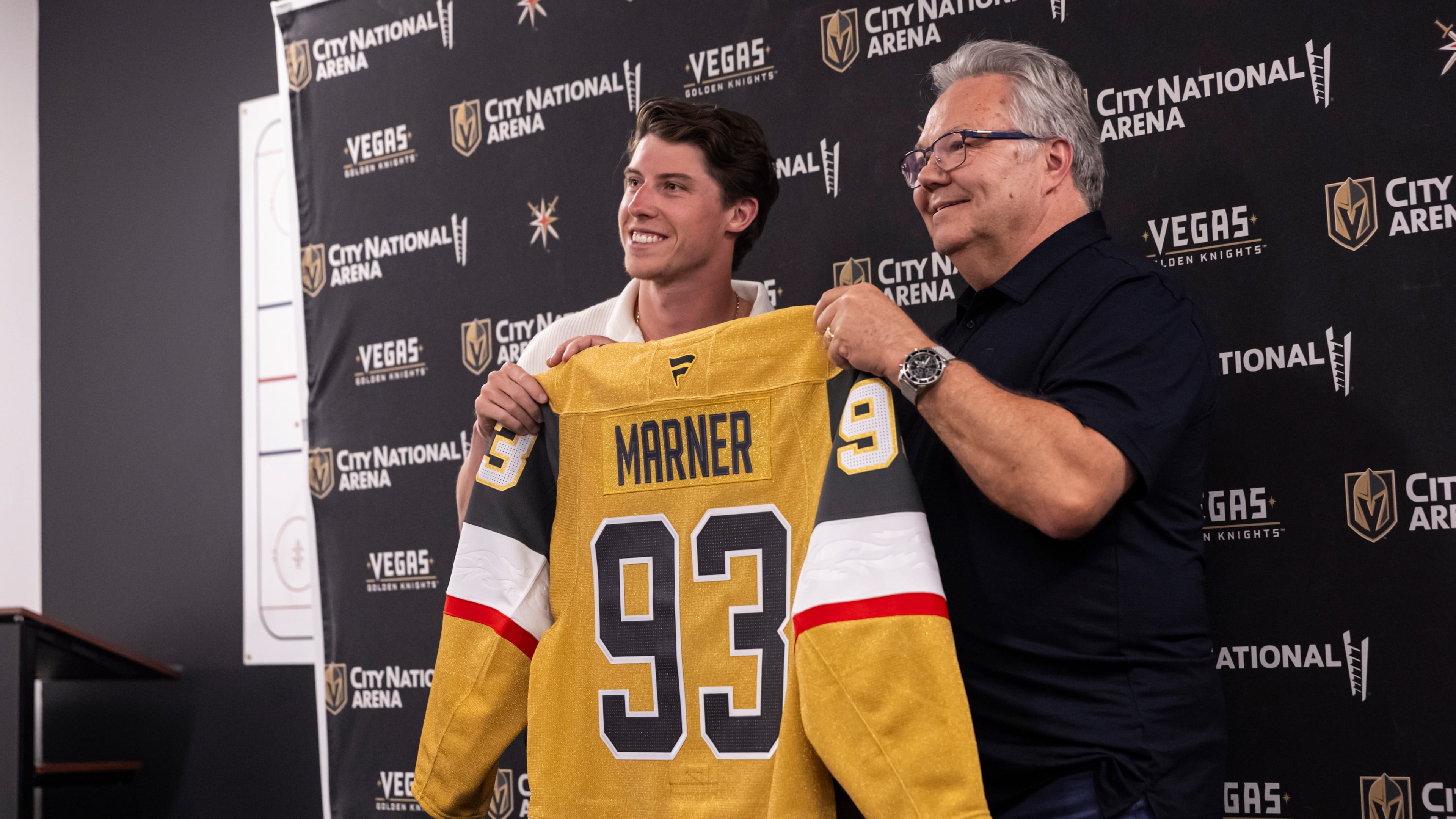 FILE - Newly-acquired Golden Knights forward Mitch Marner, left, poses for a photo with his jersey alongside general manager Kelly McCrimmon, July 1, 2025, in Las Vegas. (Chase Stevens/Las Vegas Review-Journal via AP, File)