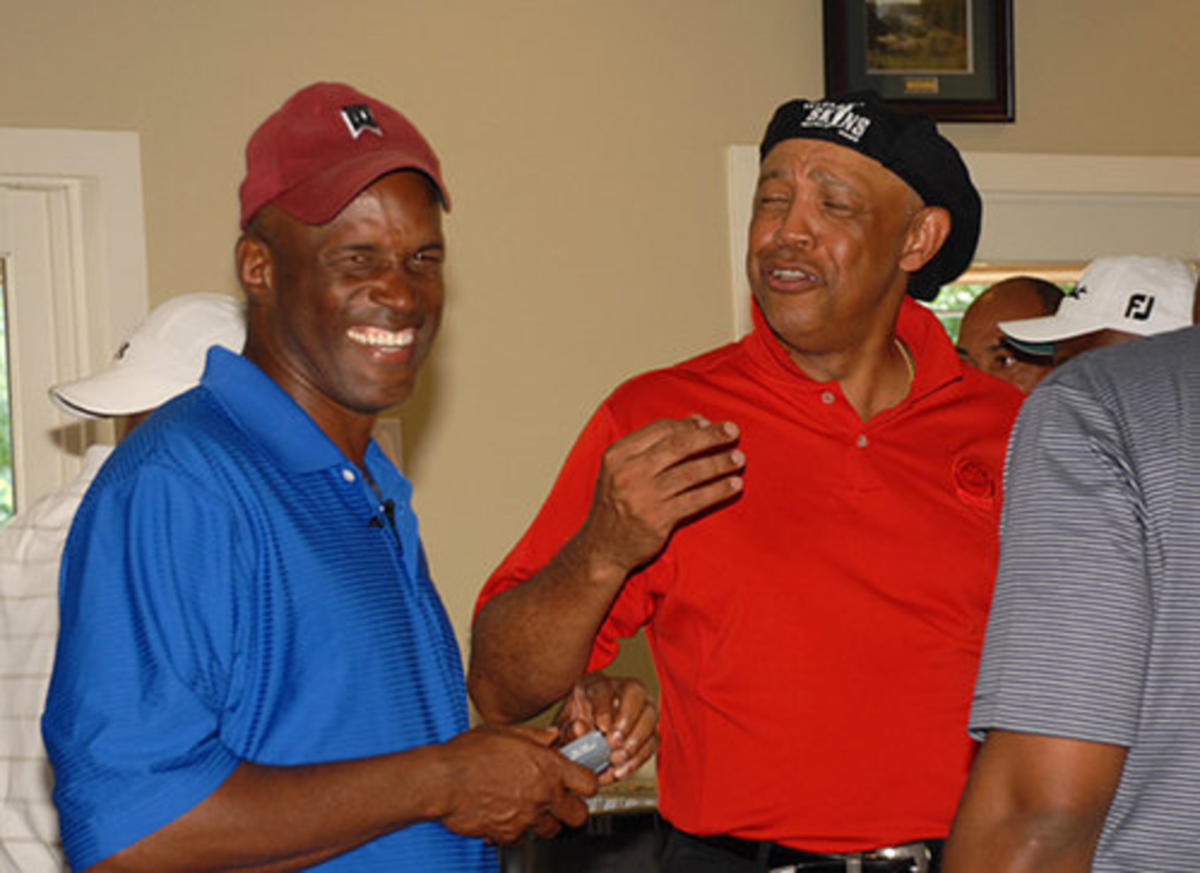 Kenny Leon laughs with John Thomas Grant Jr. about the day's game.