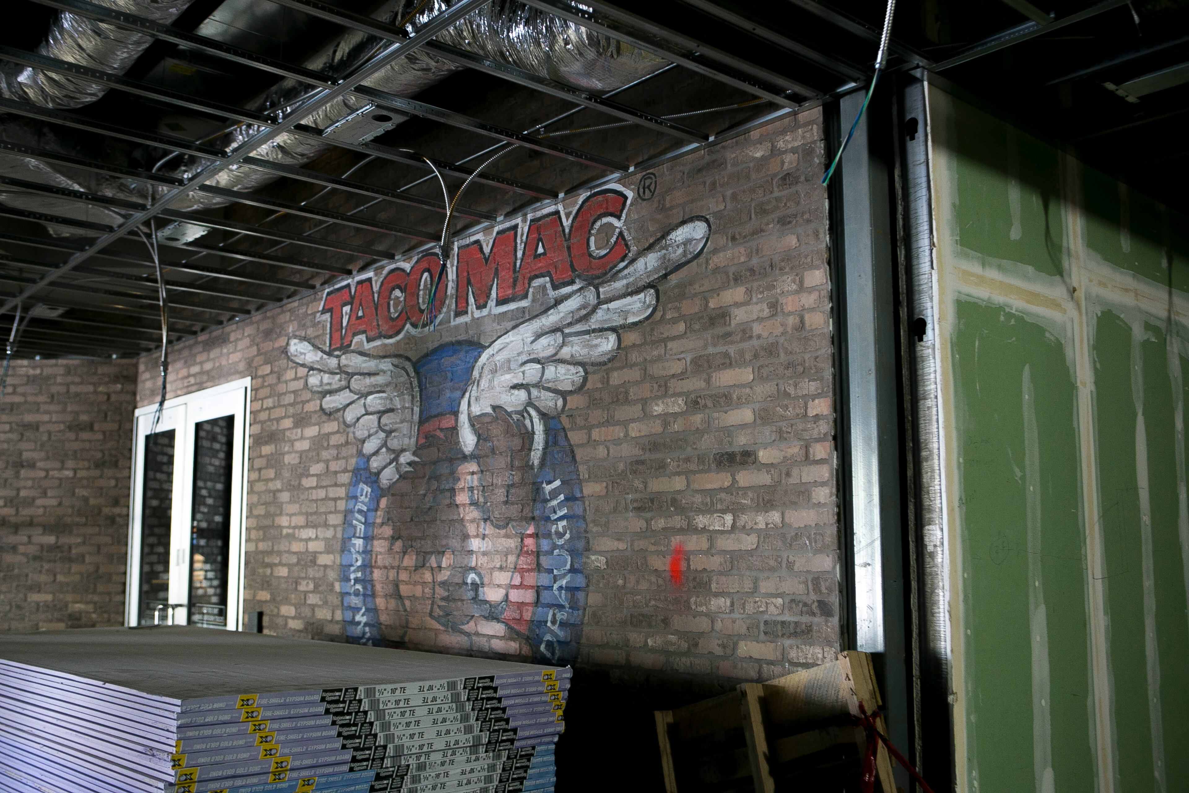 The Taco Mac logo is seen on an exposed brick wall during a guided media tour through the in-progress renovations at the State Farm Arena in Atlanta, Ga., on Thurs., Sept. 20, 2018. The renovations, which total $192.5 million, are on track to be completed by the arena's scheduled open house on October 20. The current rate of progress is about $1 million of work per day, according to Brett Stefansson, Atlanta Hawks executive vice president and general manager of State Farm Arena. (CASEY SYKES, CASEYLANESYKES@GMAIL.COM)