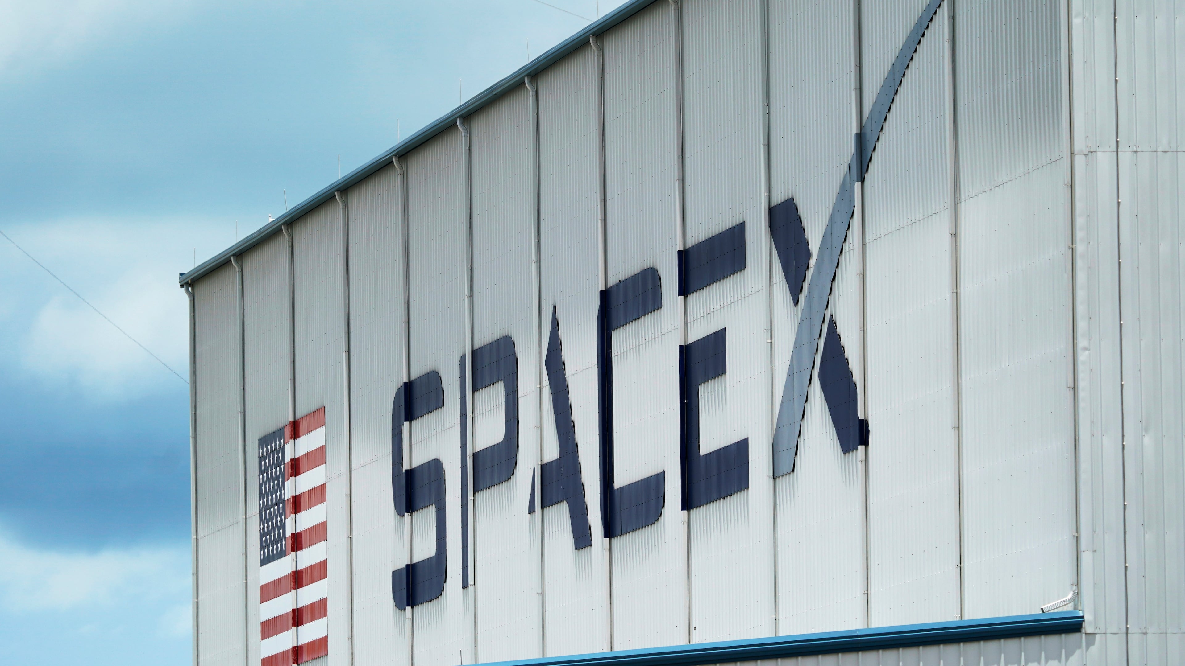 FILE - The SpaceX logo is displayed on a building, May 26, 2020, at the Kennedy Space Center in Cape Canaveral, Fla. (AP Photo/David J. Phillip, File)