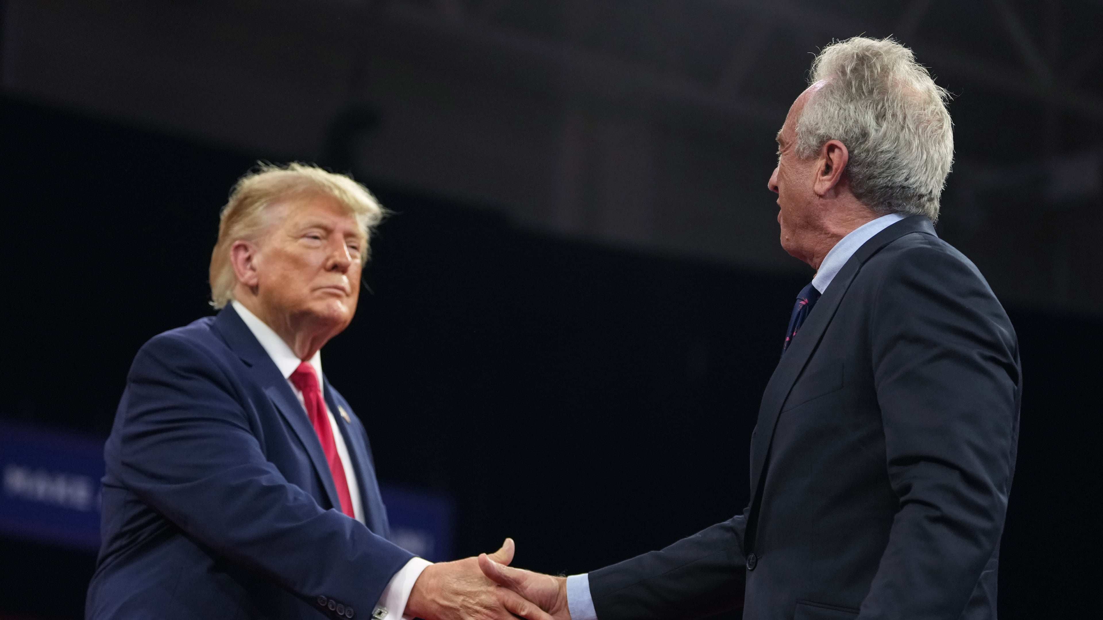 President Donald Trump shakes hands with Health and Human Services Secretary Robert F. Kennedy Jr. at a campaign rally at Alico Arena on the campus of Florida Gulf Coast University, Friday, Oct. 23, 2026, in Fort Myers, Fla. (AP Photo/Mark Schiefelbein)