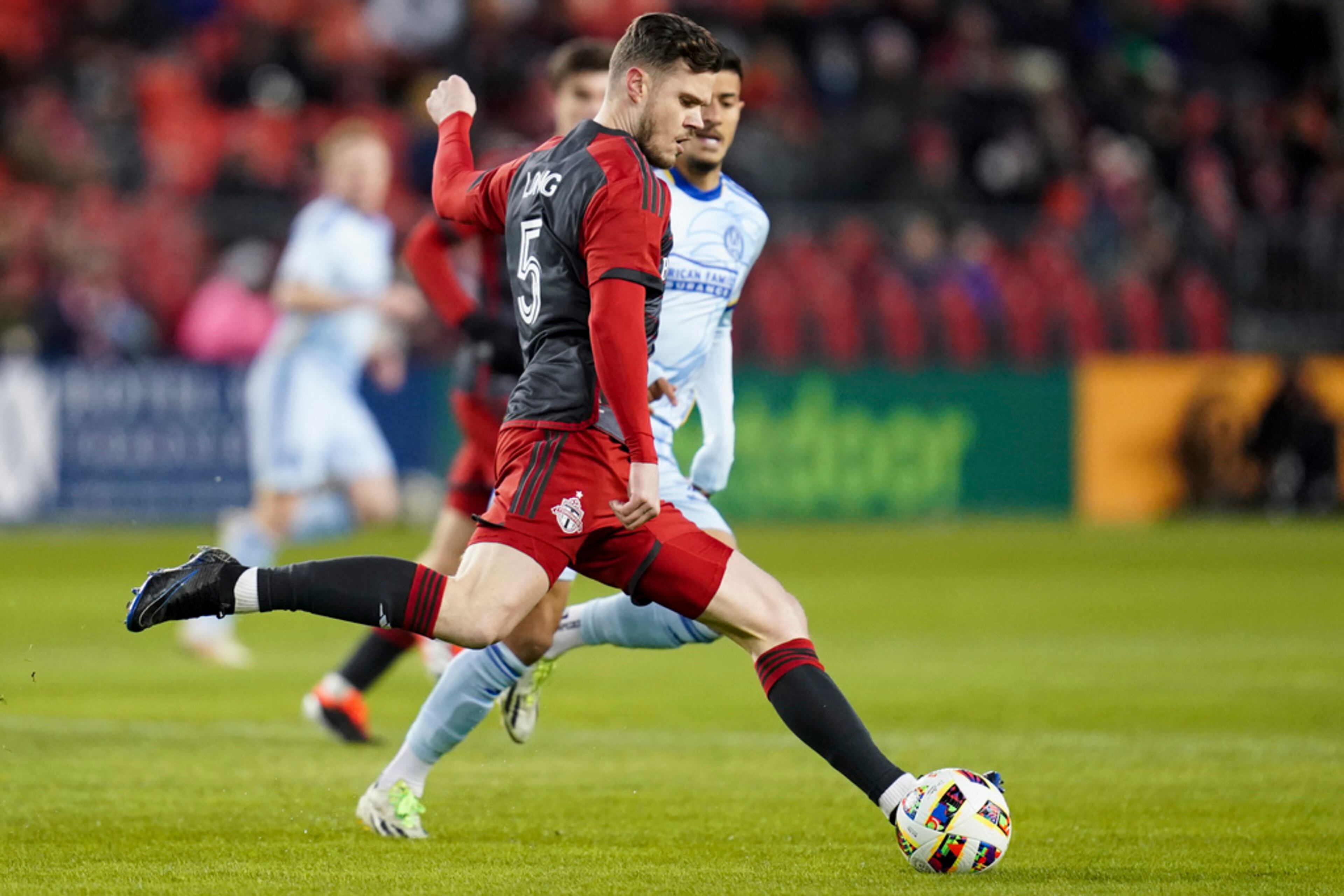 Toronto FC defender Kevin Long (5) kicks the ball during the first half of the team's MLS soccer match against Atlanta United in Toronto on Saturday, March 23, 2024. (Arlyn McAdorey/The Canadian Press via AP)