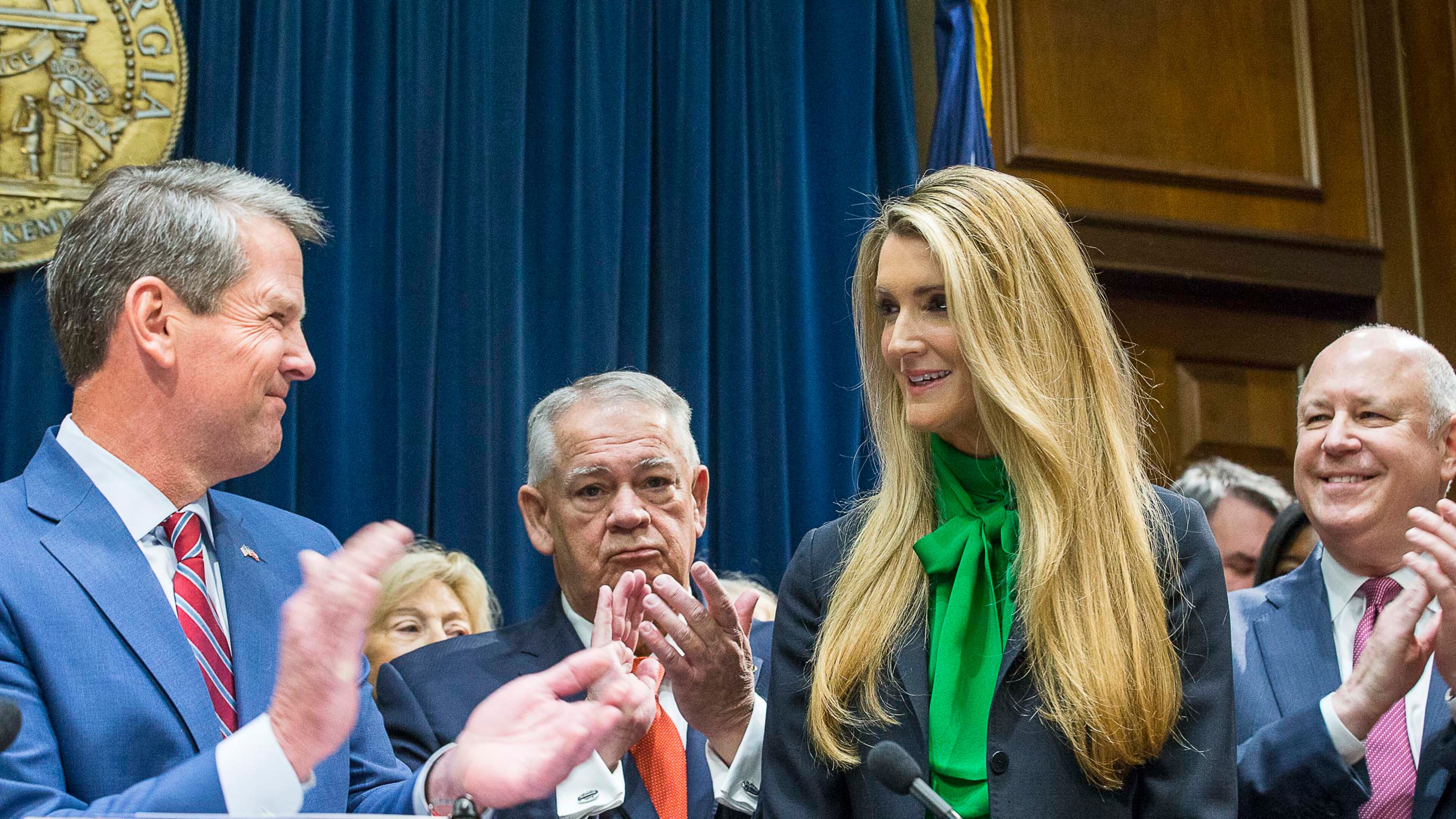 12/04/2019 -- Atlanta, Georgia -- Lawmakers applaud as newly appointed U.S. Senator Kelly Loeffler (second from right) is introduced by Georgia Gov. Bria Kemp (left) during a press conference in the Governor's office at the Georgia State Capitol Building, Wednesday, December 4, 2019. Georgia Gov. Brian Kemp appointed Kelly Loeffler to the U.S. Senate to take the place of U.S. Senator Johnny Isakson, who is stepping down for health reasons. (ALYSSA POINTER/ALYSSA.POINTER@AJC.COM)