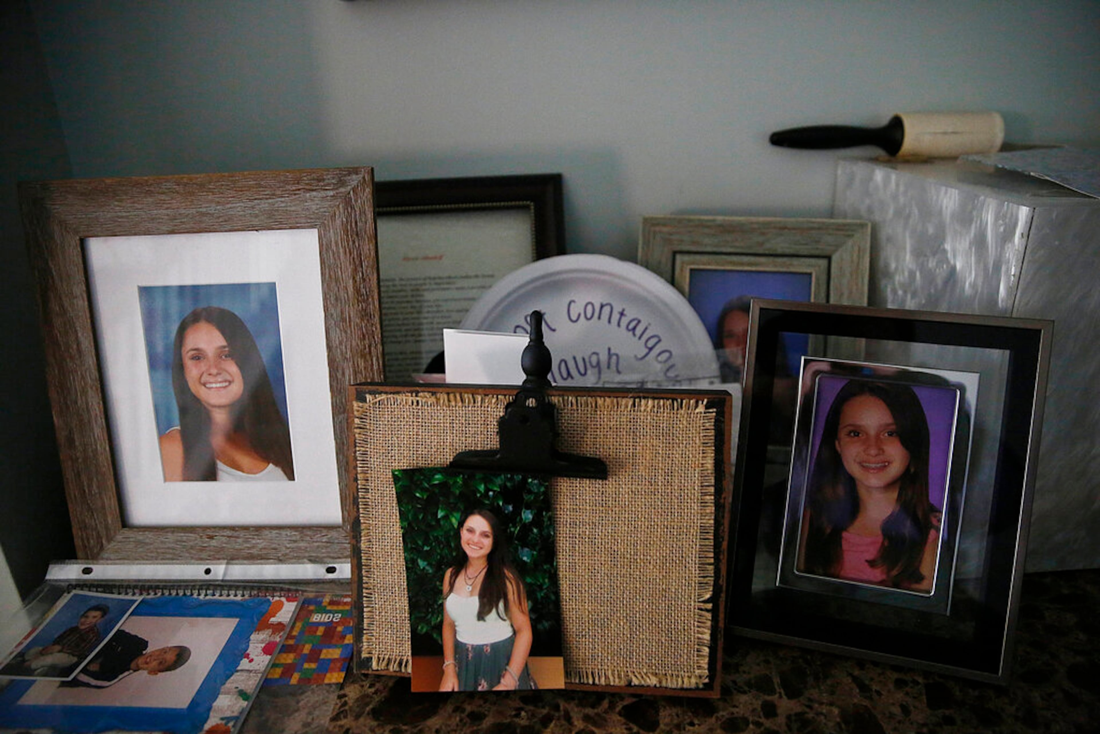 FILE - In this Jan. 30, 2019 file photo, photographs of 14-year-old Alyssa Alhadeff, one of 17 people killed by a gunman who stalked the halls of Marjory Stoneman Douglas High School, sit on a table in her home in Parkland, Fla.